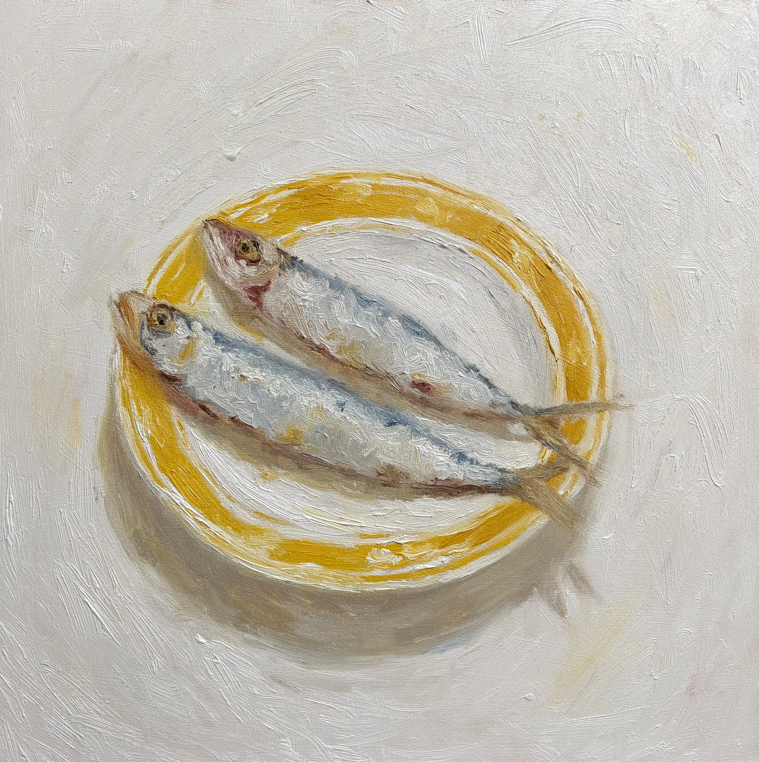 Sardines at a yellow plate two