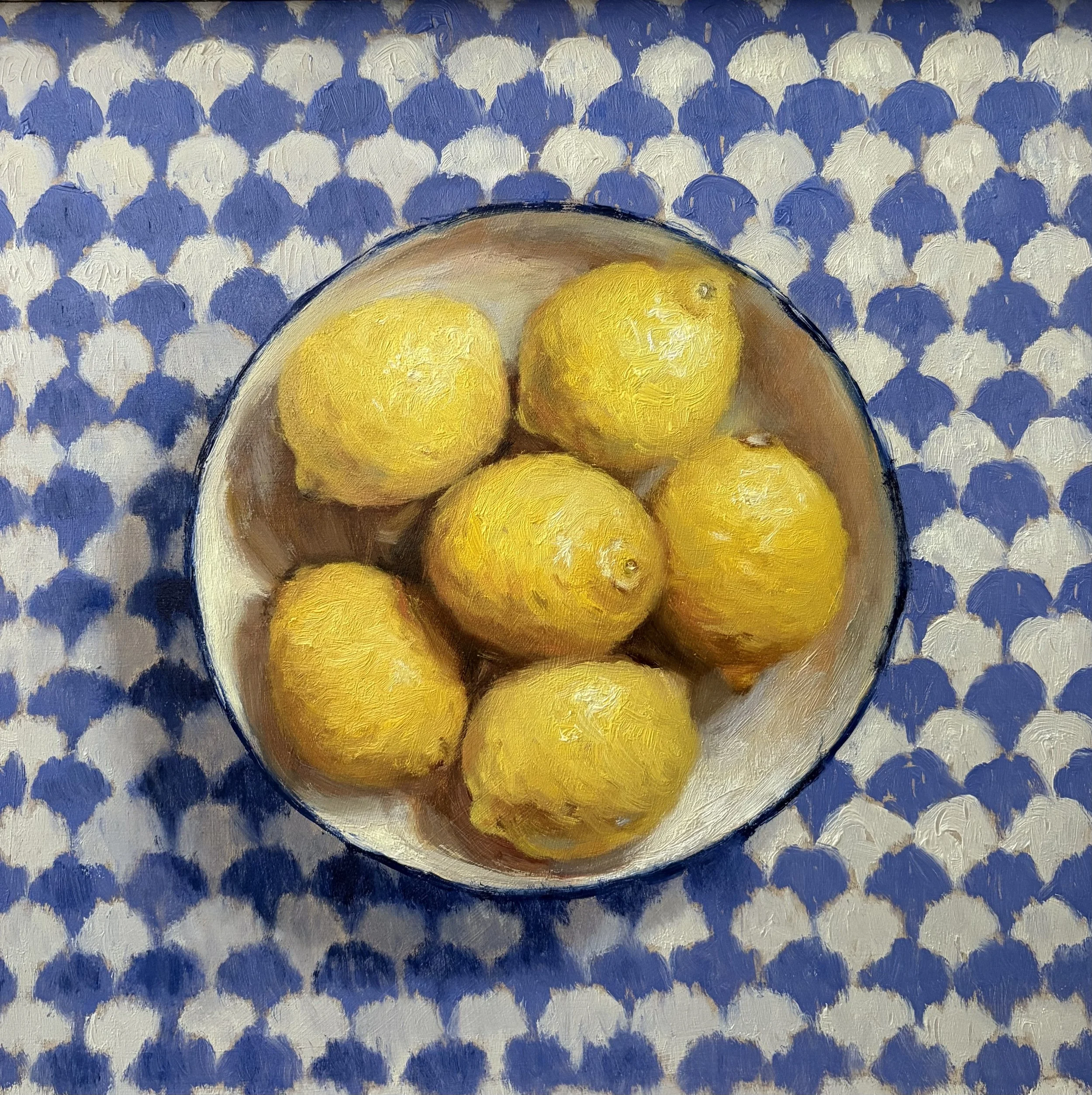 Bowl full of lemons on patterned background