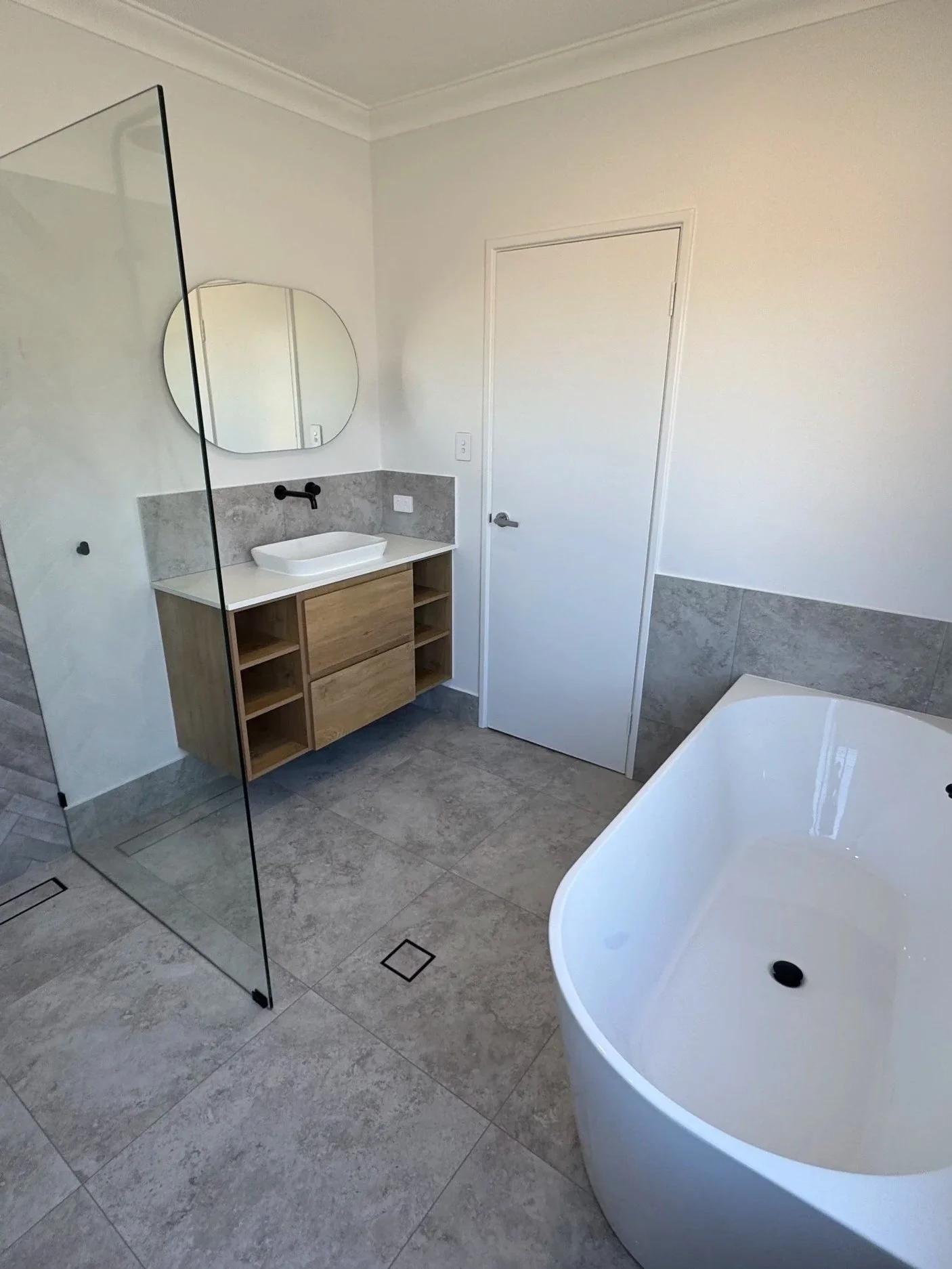 Dianella bathroom remodel with white bathtub and open shower