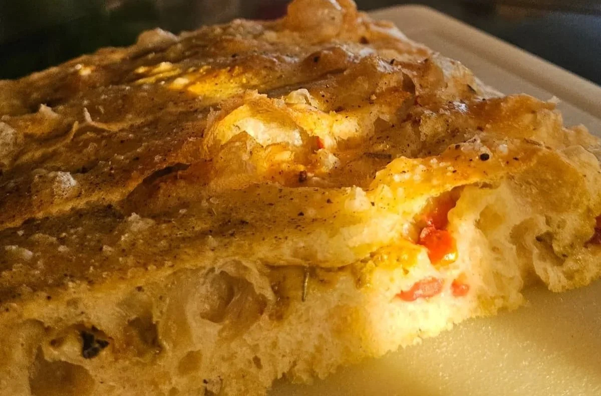 Mediterranean focaccia with sun-dried tomatoes and green olive paste