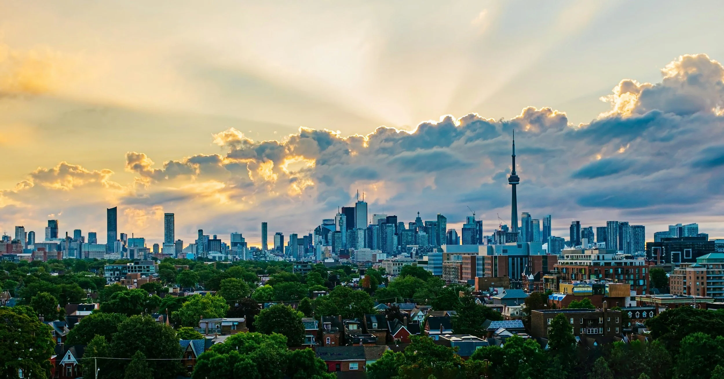 Image is of the Toronto Skyline, from the west end, in summer