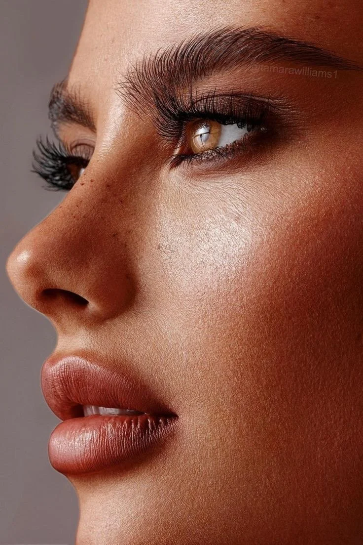 Close-up of a woman's face highlighting eyes, eyelashes, nose, and lips.