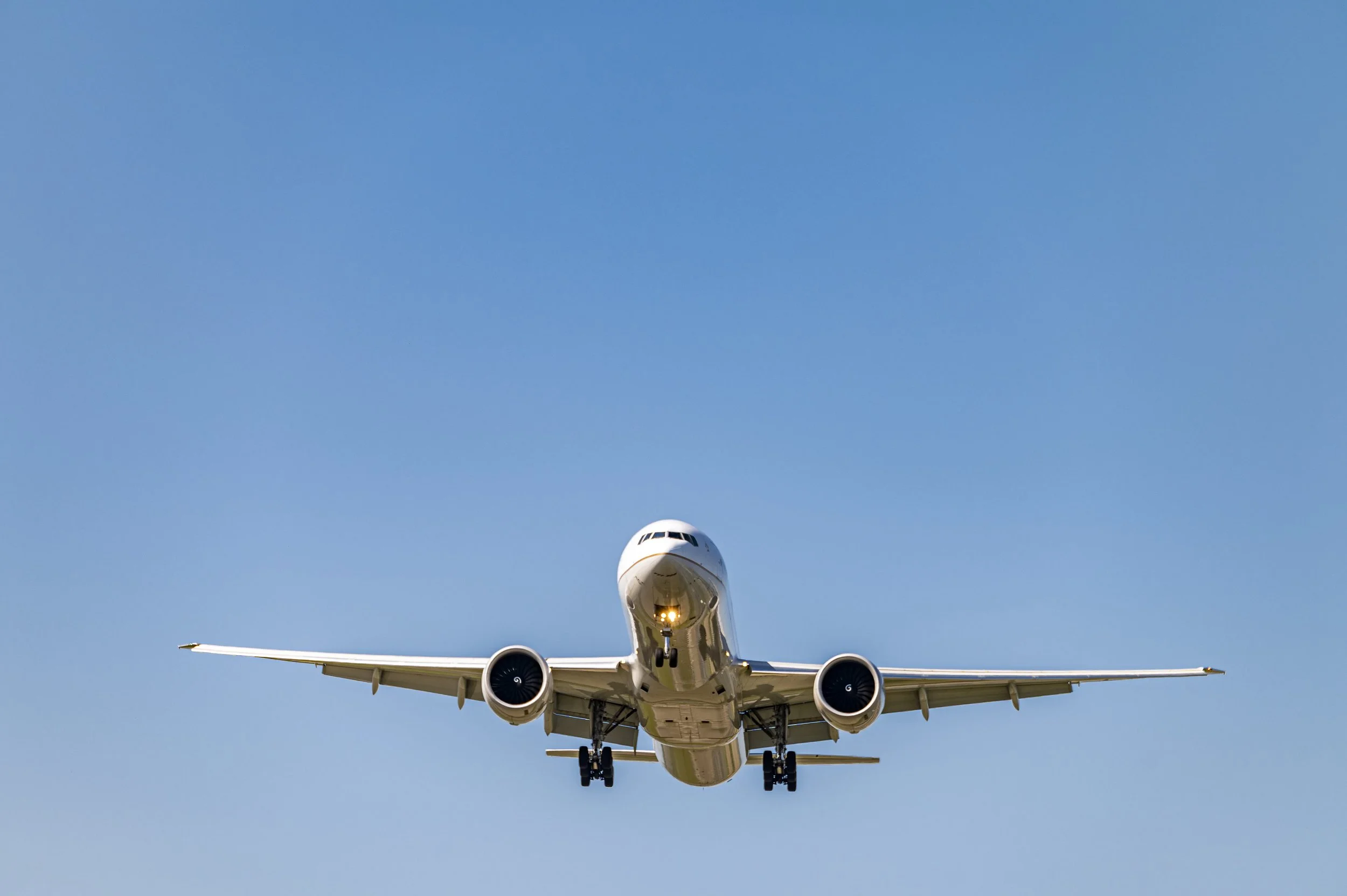 low-angle-shot-airplane-flying-closer-daytime.jpg