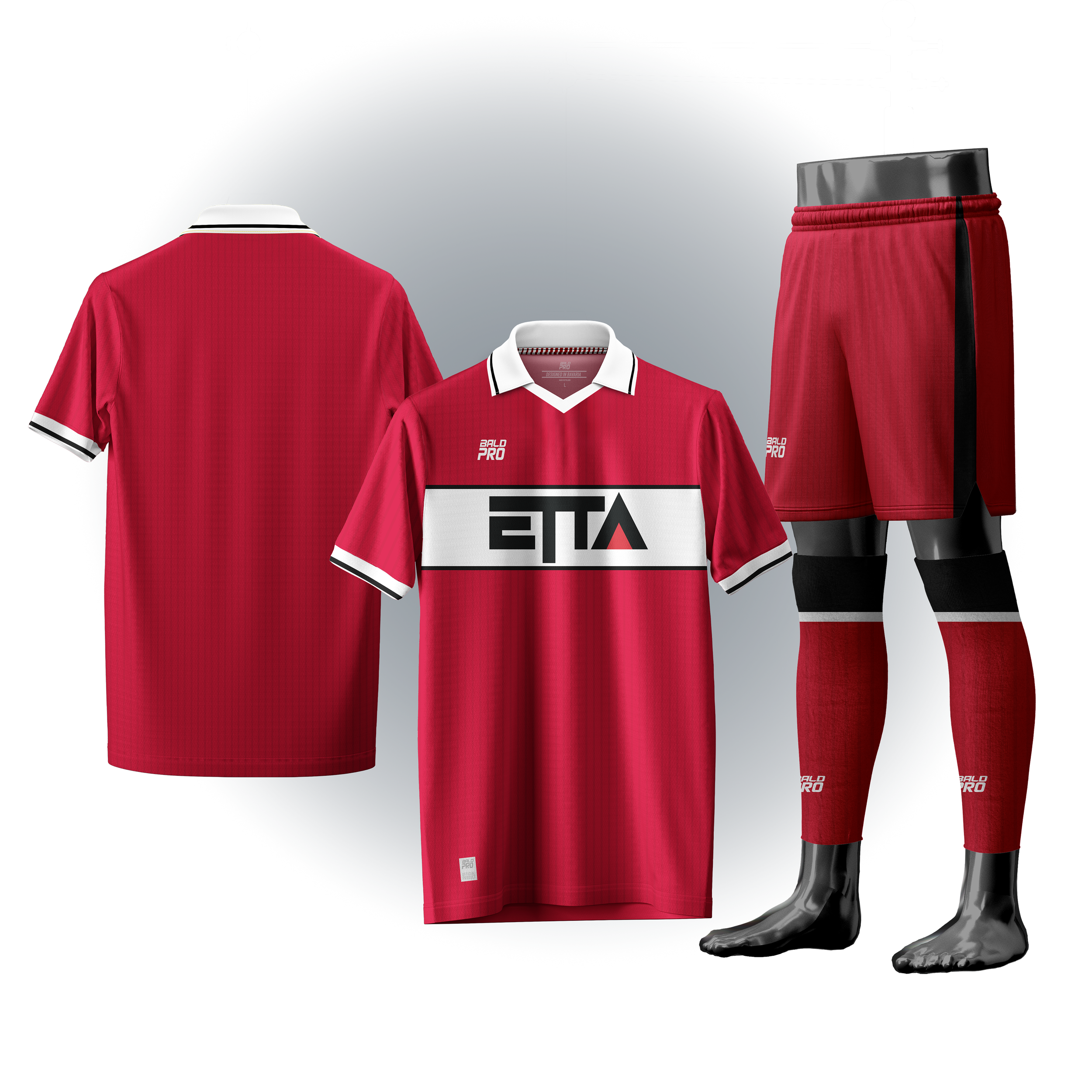 Ein rotes Fußballtrikot mit weißen Streifen am Kragen und an den Ärmeln, ein rotes kurzärmliges T-Shirt mit weißen und schwarzen Elementen, rote Shorts mit schwarzen und weißen Streifen, schwarze Stutzen mit roten Elementen und dem Logo 'BALD PRO'.