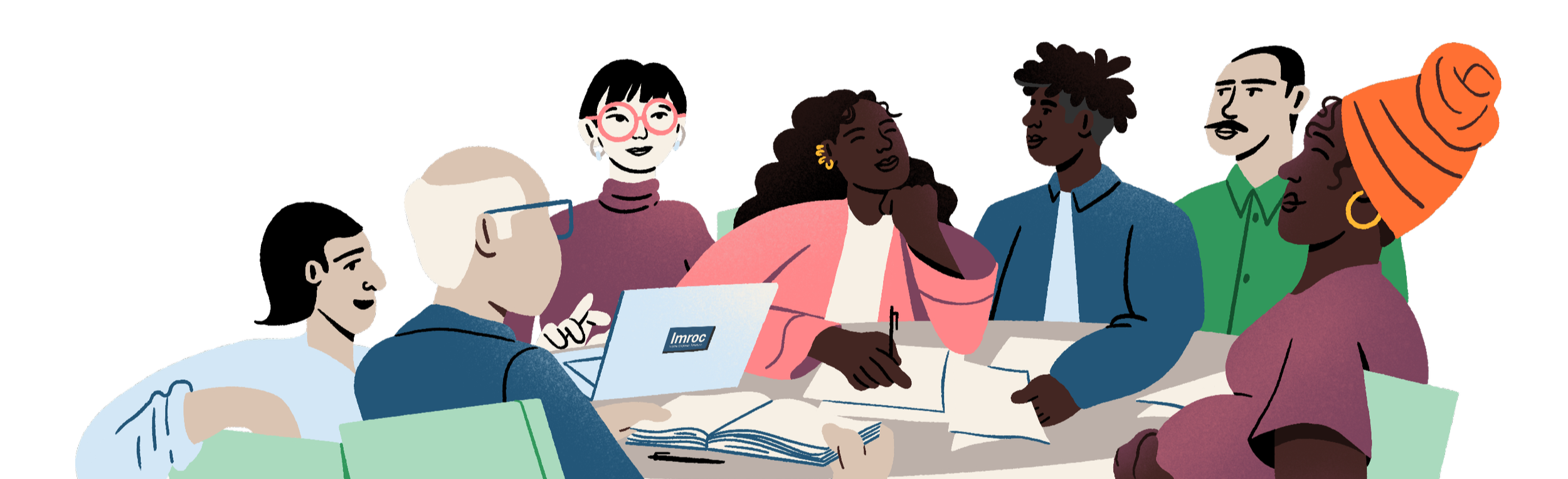 A diverse group of people gathered around a table engaged in discussion, some taking notes and others listening attentively, with a laptop and open books on the table.