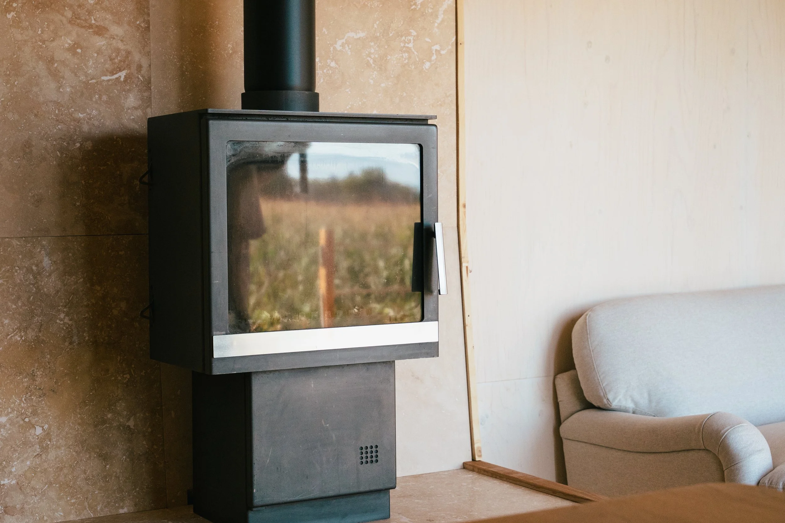  wood stove in woodland cabin. fireplace tools including a poker, a brush, and a scoop, all on a stand. a hot tub, luxury off grid stay. In Cotswolds village, Near Bibury and Cirencester, Pig Hotel, Village pub