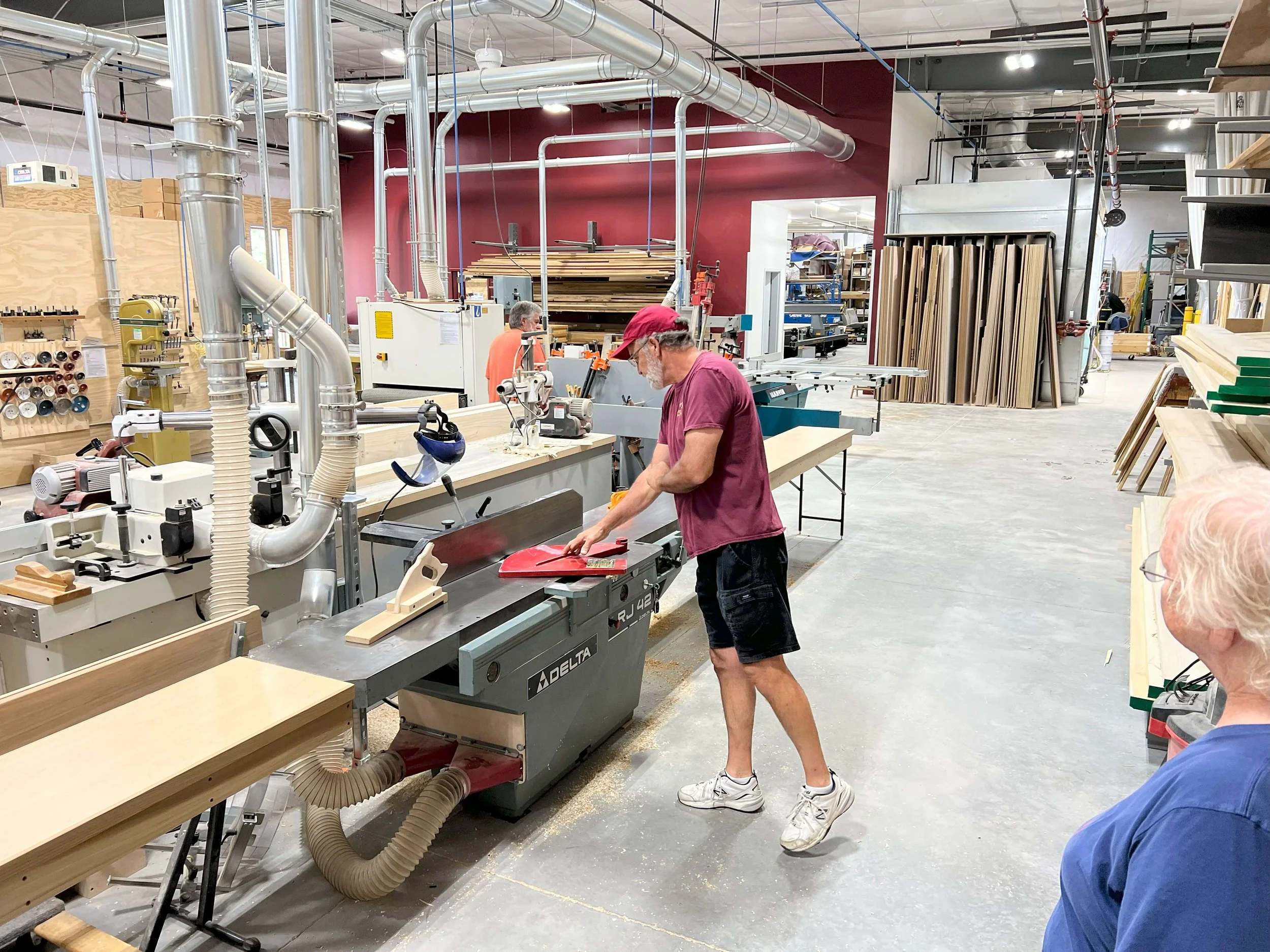 Shop craftsman Kent Brown showing the 18" Delta jointer in the Dobson Pipe Organ Builders' new shop.