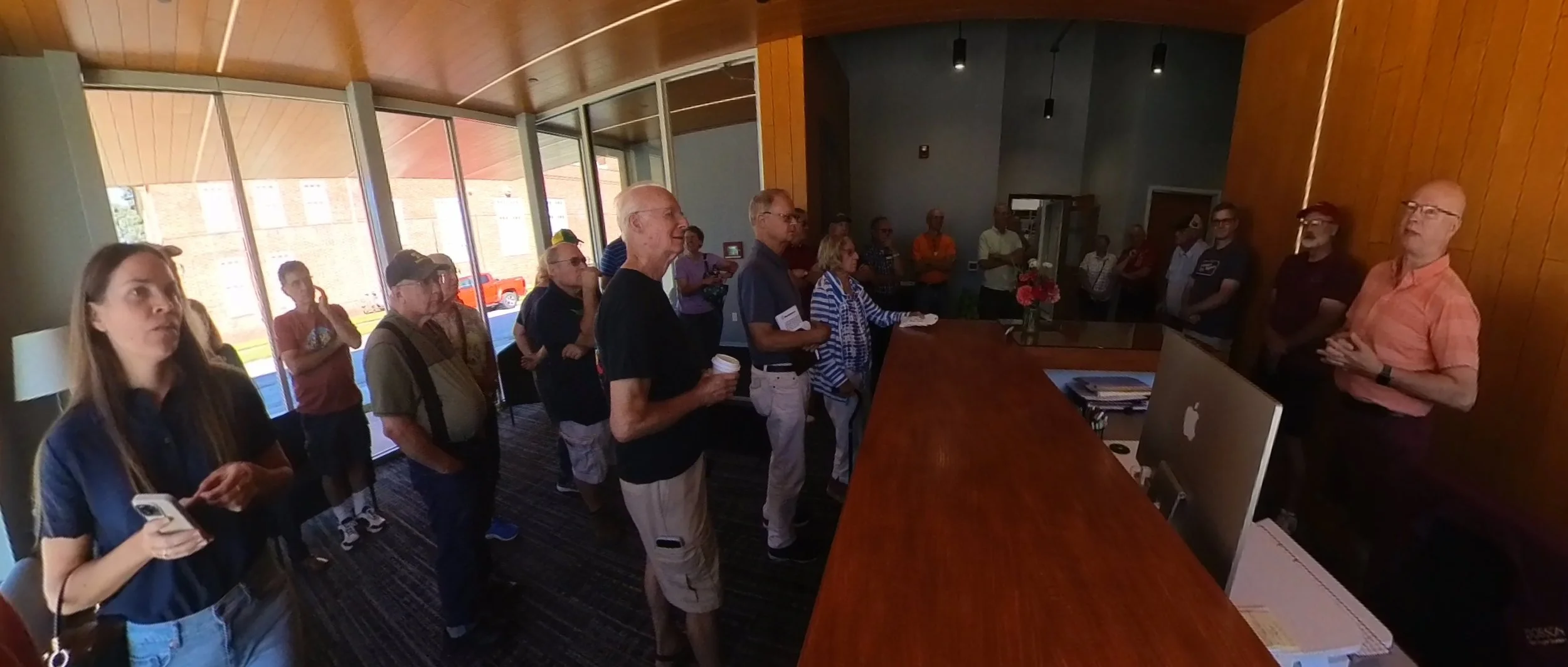 John Panning, right, owner of Dobson Pipe Organ Builders, provides a history of the company to about 30 club members and spouses.
