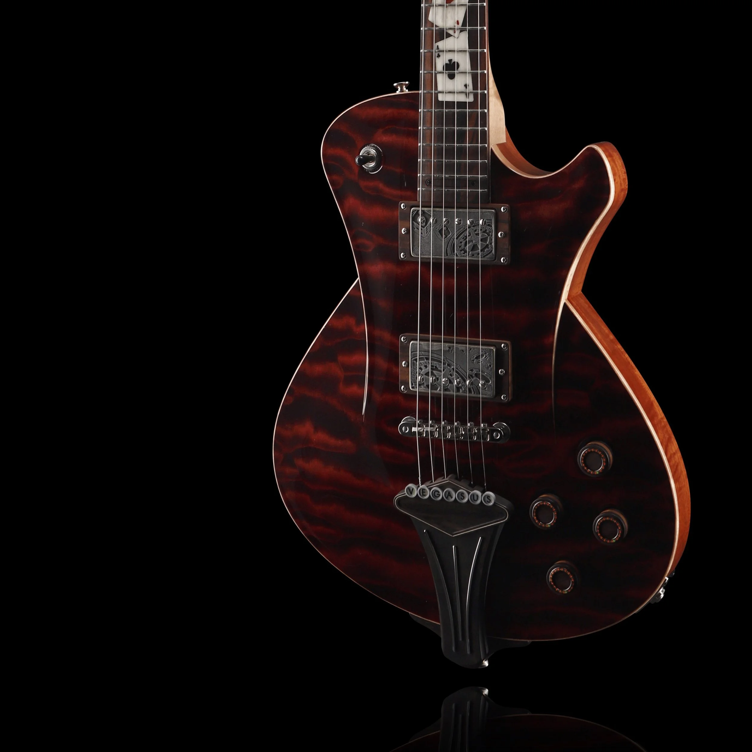 Electric Frank Hartung guitar with a dark red and black striped finish, offset against a black background.
