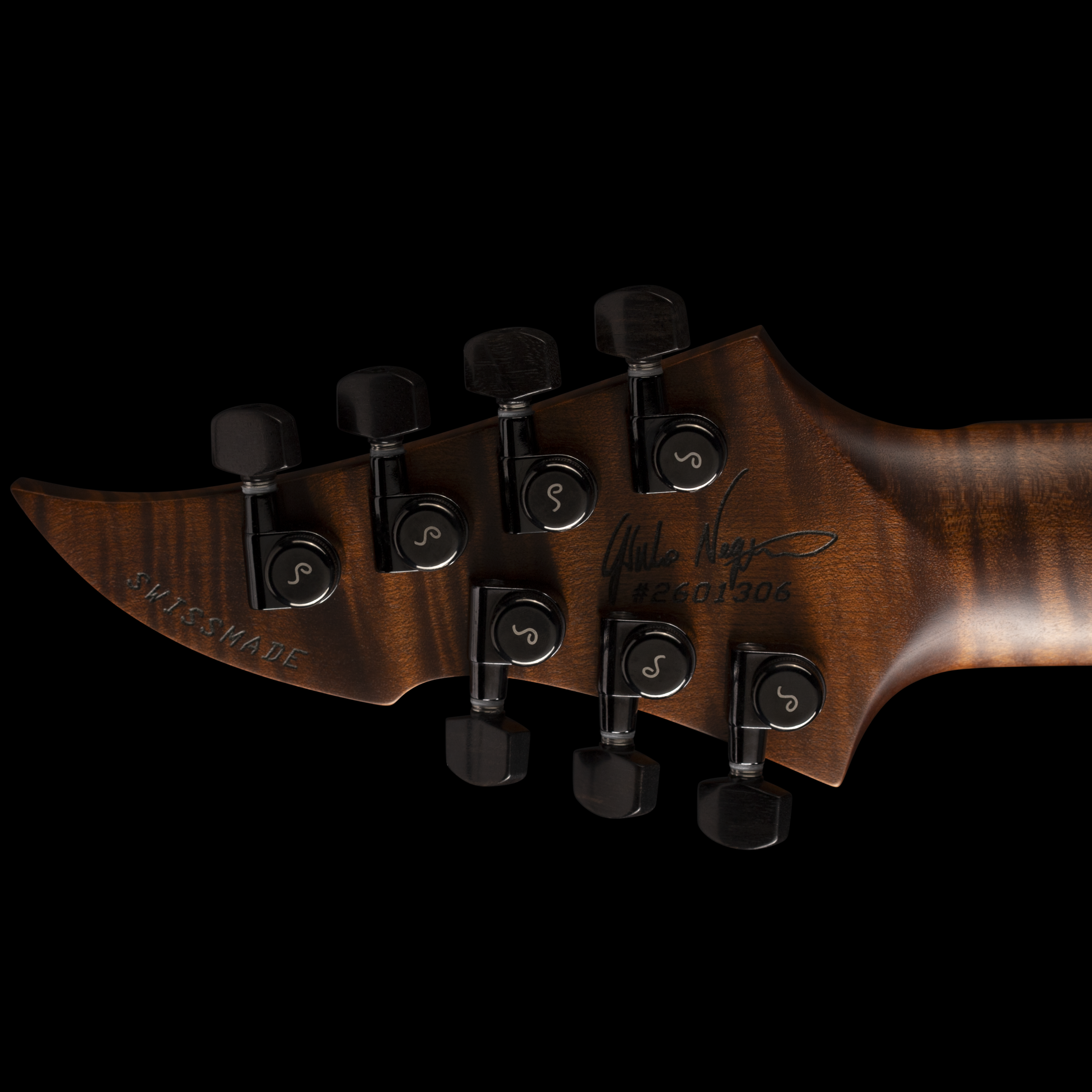 Close-up of a GNG Giulio Negrin guitar headstock with tuning pegs on a black background.