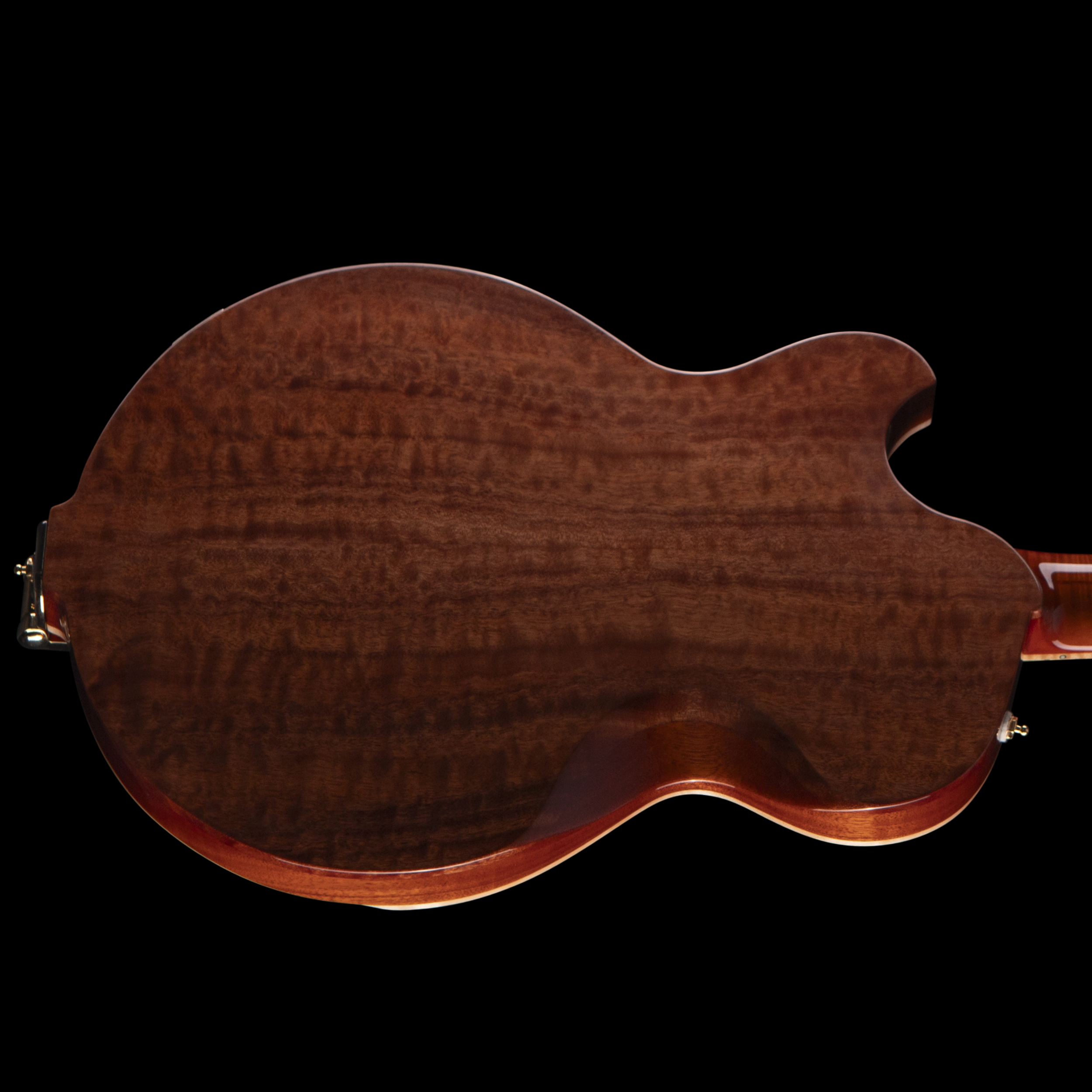 Close-up of a wooden Djerjinski with a smooth, curved edge against a black background.