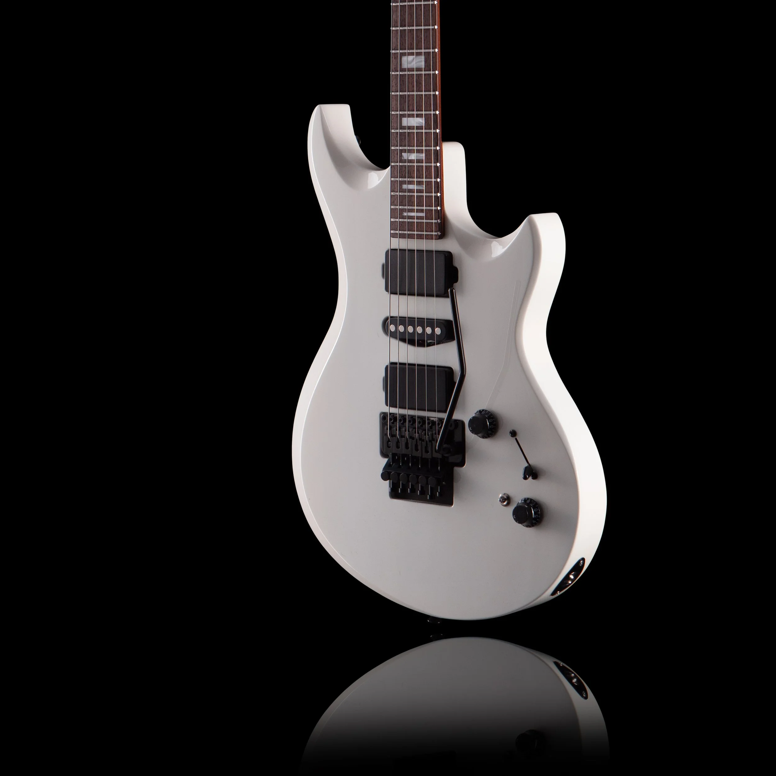 A white electric Anderson guitarworks guitar with black hardware, showing its body, neck, and strings, reflected on a shiny surface against a black background.