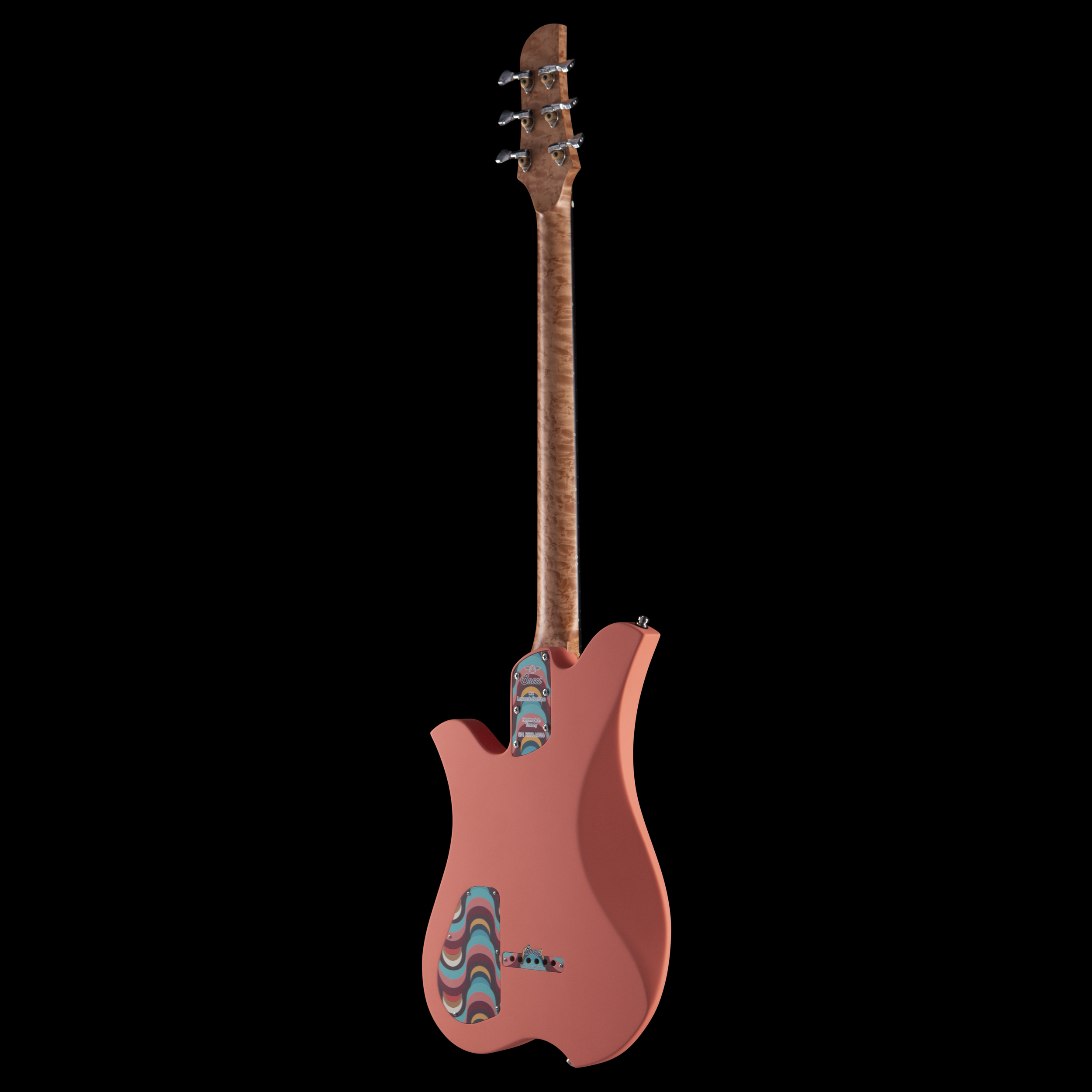 A pink electric Bacci guitar with a colorful, swirl-patterned pickguard against a black background.