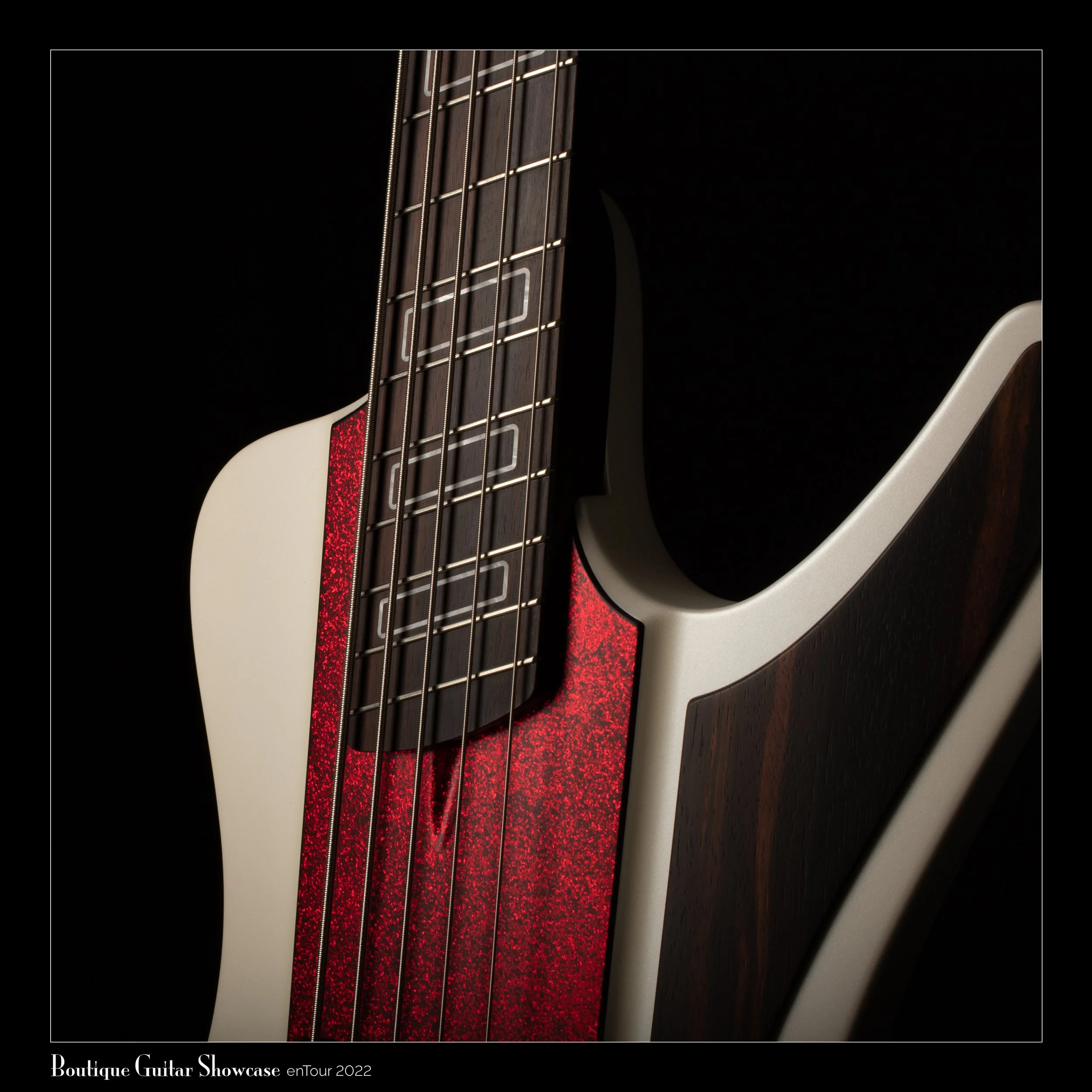 Close-up of an electric guitar with a red glittery pickguard and sleek wood detailing on a dark background.