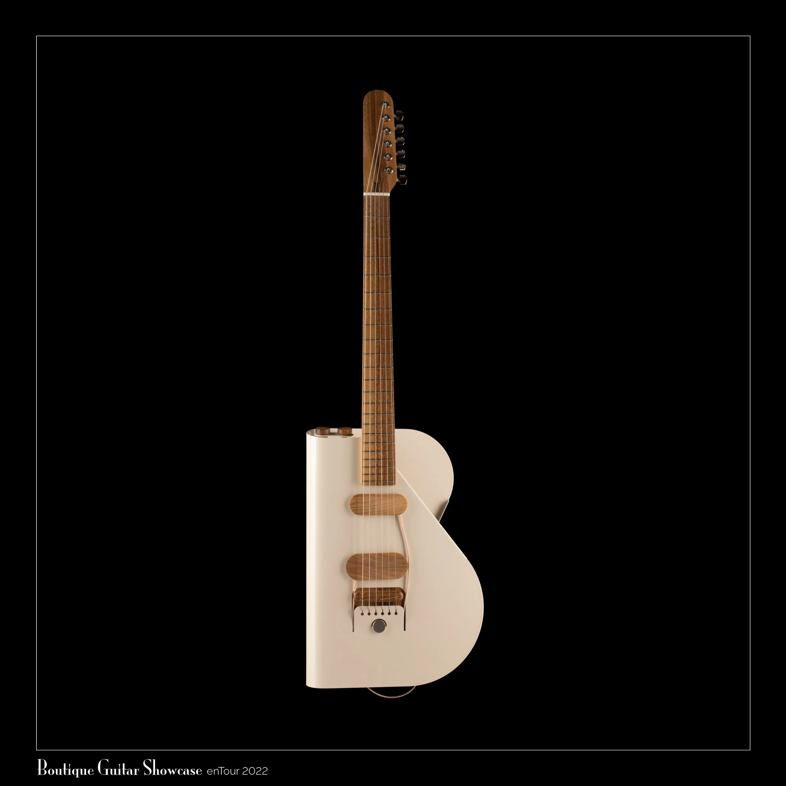 A white electric Verso Cosmo guitar with a wooden fretboard set against a black background. The guitar has a simple design with six strings and a black control knob at the bottom. Text at the bottom reads 'Boutique Guitar Showcase enTour 2022.'