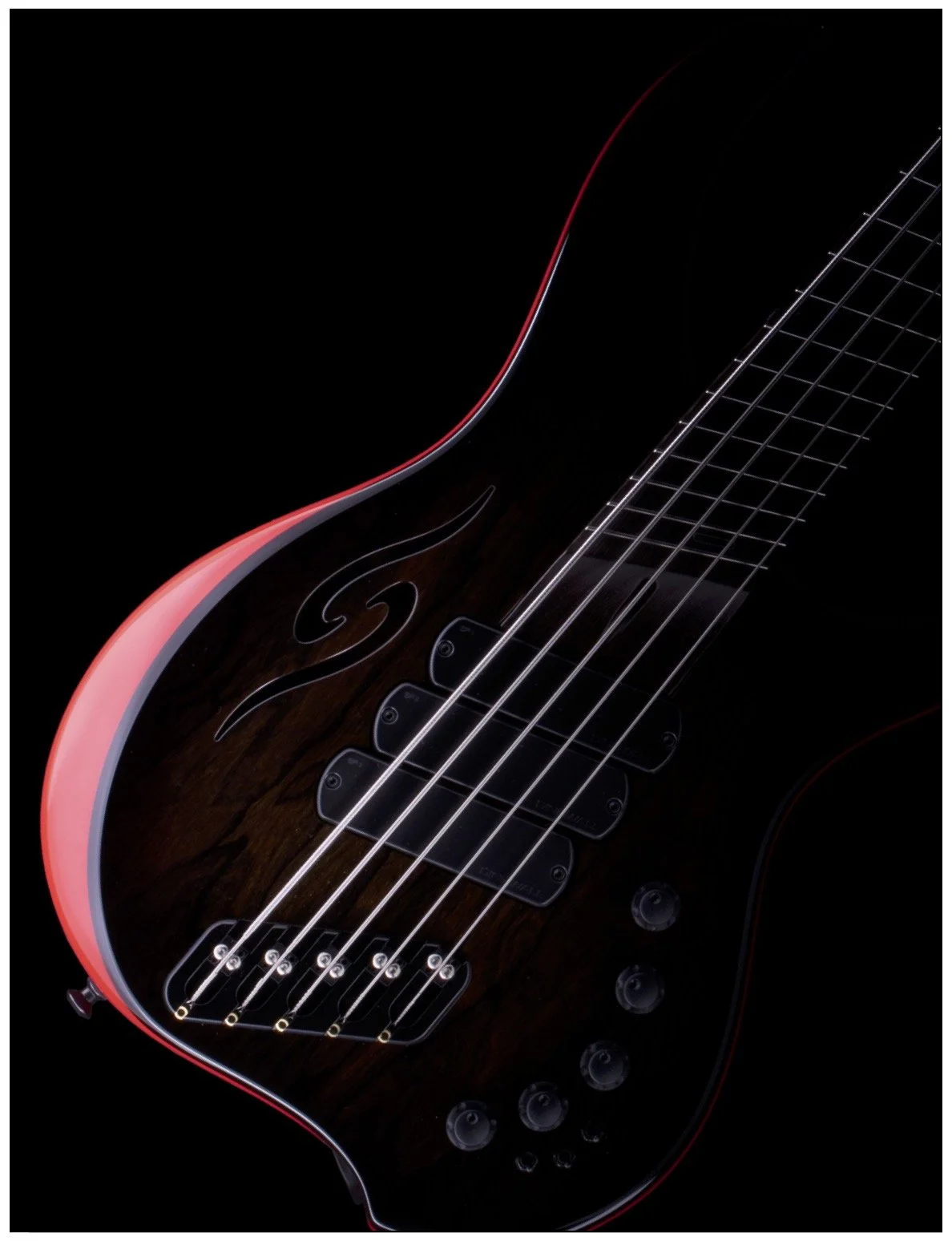 Close-up of a dark-colored electric bass guitar with five strings, decorative engraving, and red edges on a black background.