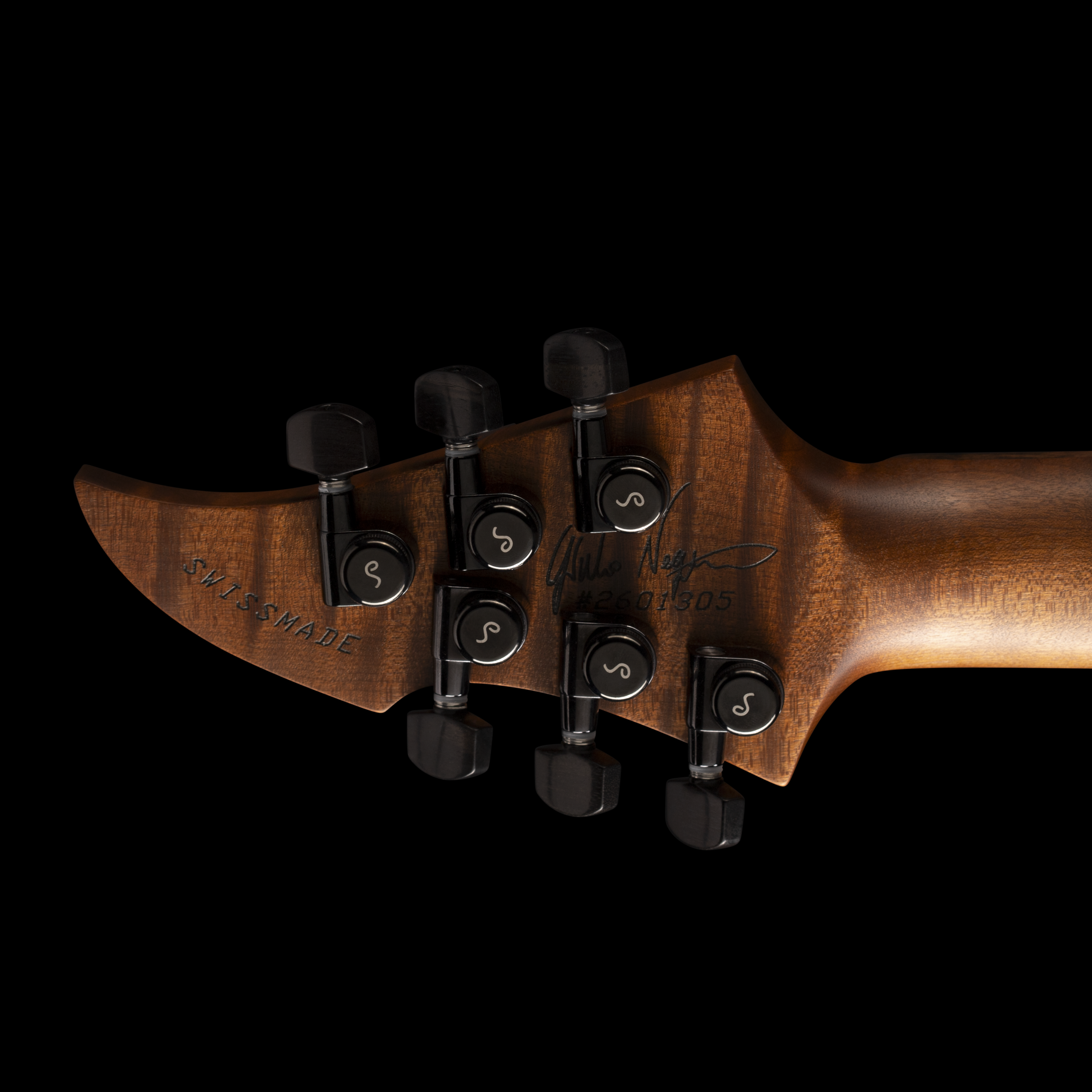 Close-up of the GNG Giulio Negrin Guitar headstock of a guitar showing tuning pegs and part of the nut against a black background.