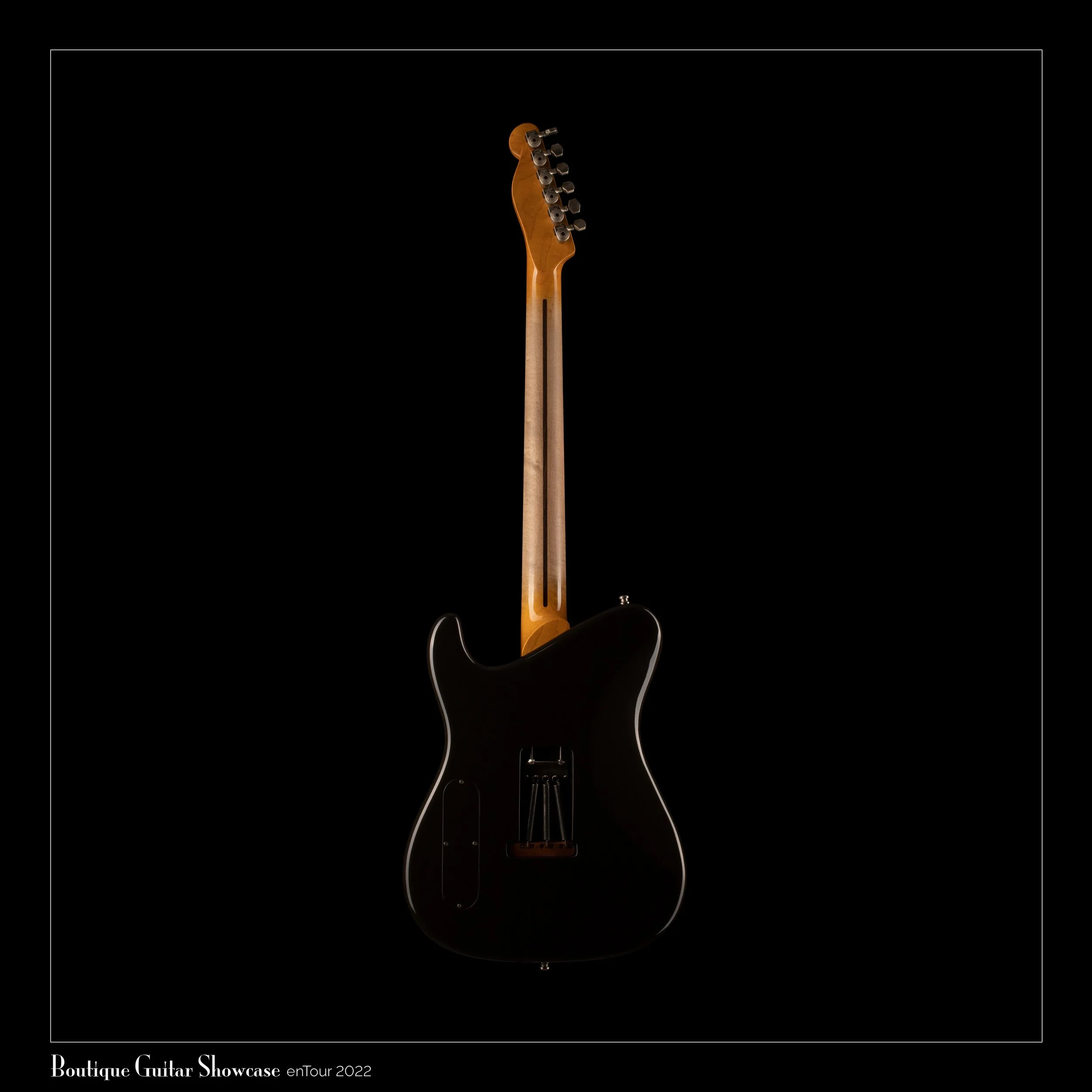 Back of a Tausch electric guitar with a wooden neck, displayed against a black background.