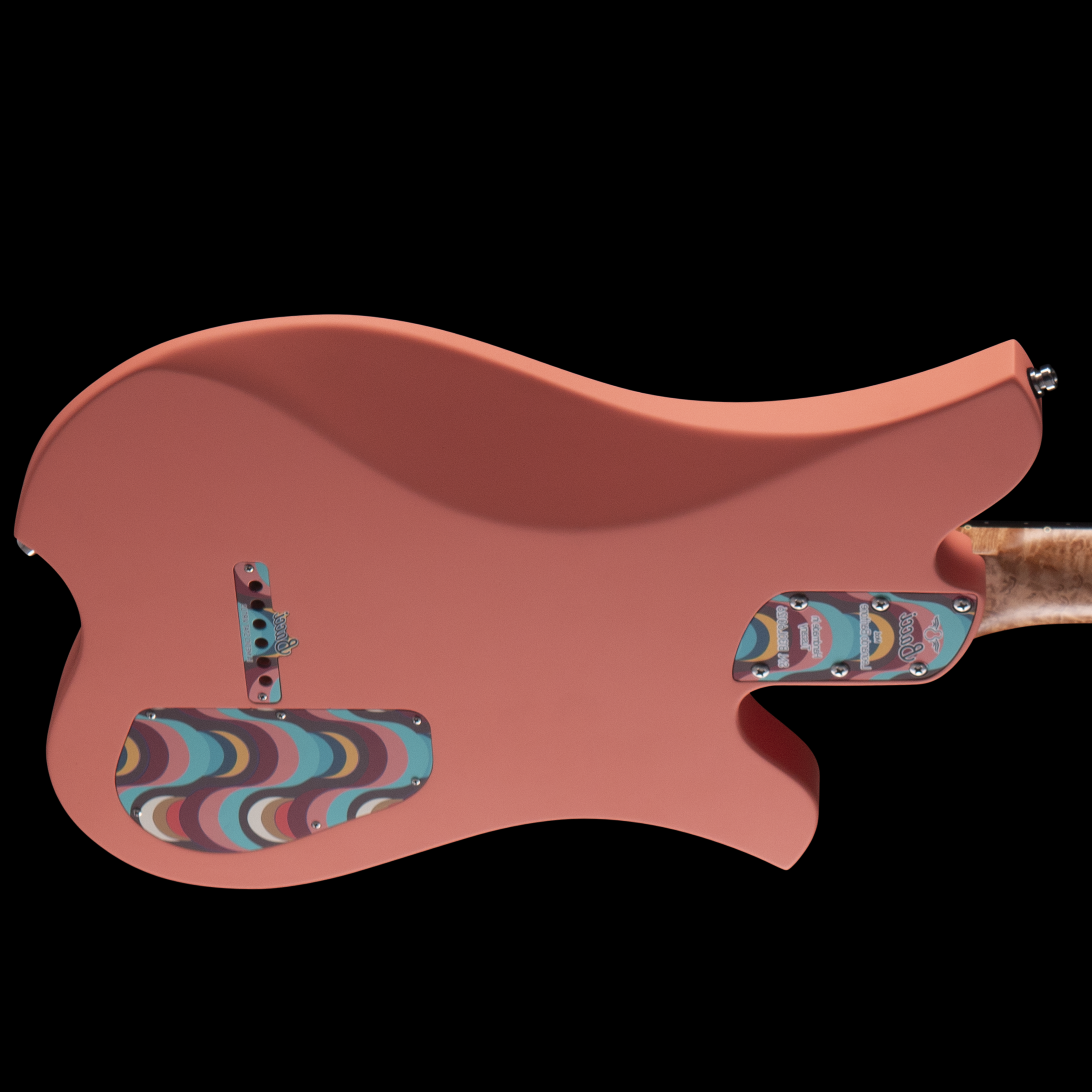 A pink Bacci electric guitar with a colorful rainbow-patterned pickguard and chrome hardware on a black background.