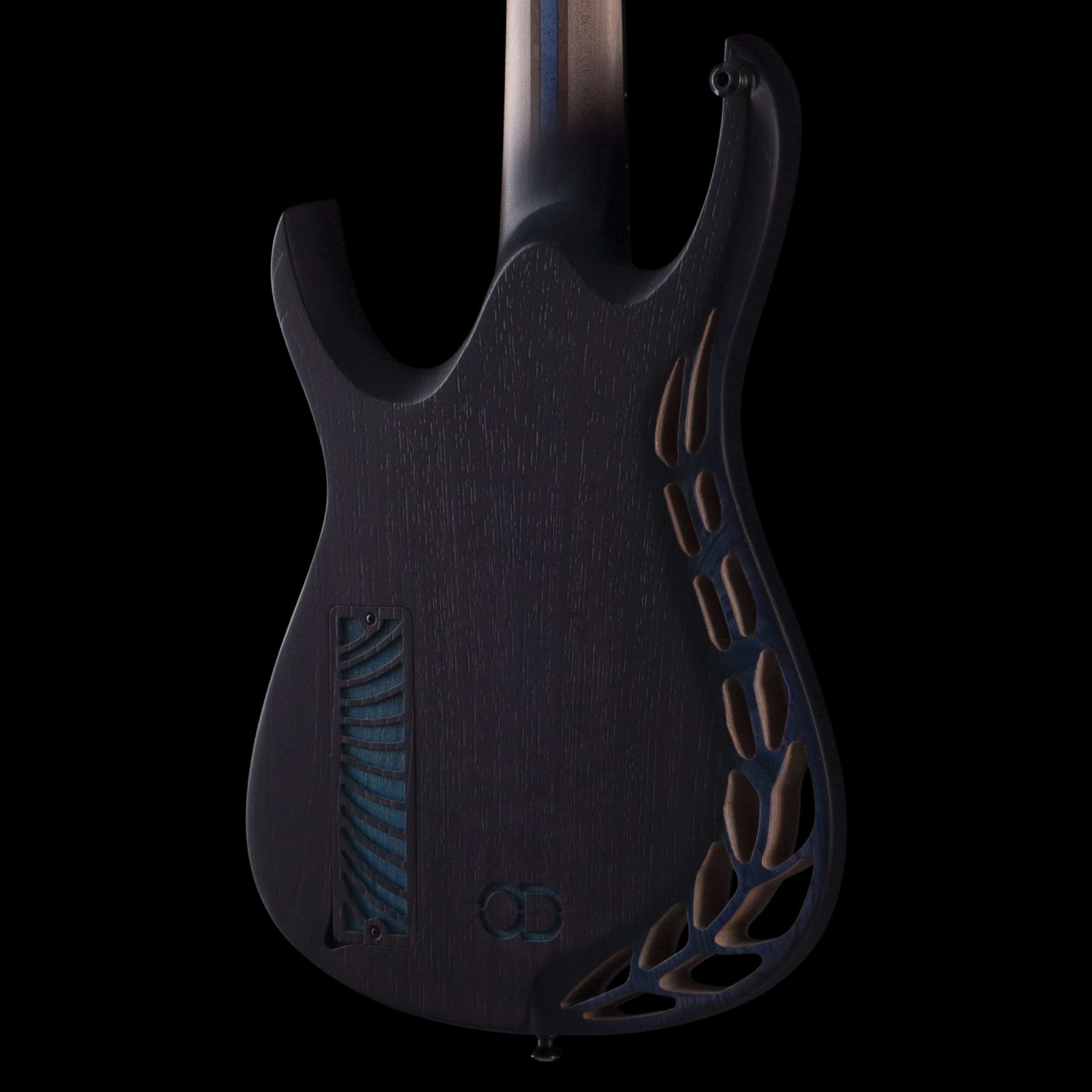 Close-up of an electric OD guitar's body back with relief geometric cuts.