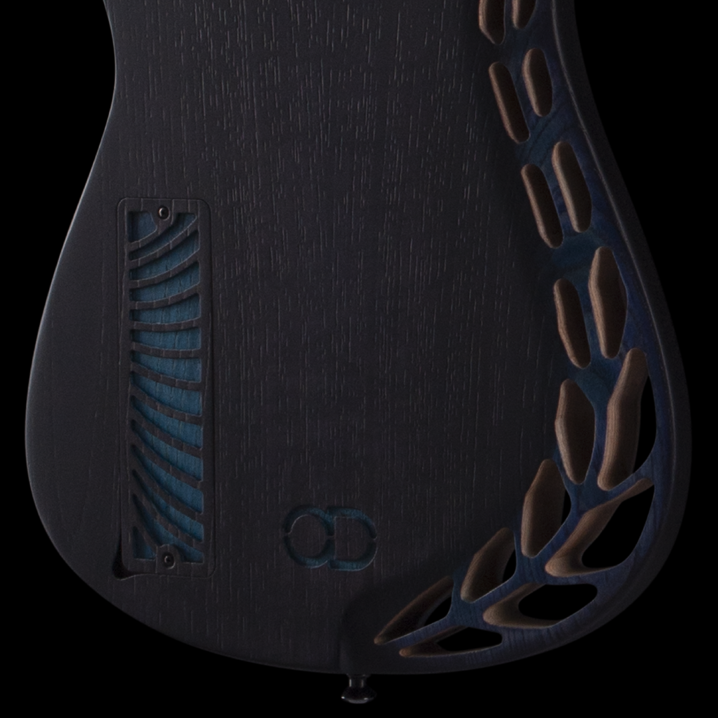 Close-up of an electric OD guitar's body back with relief geometric cuts.