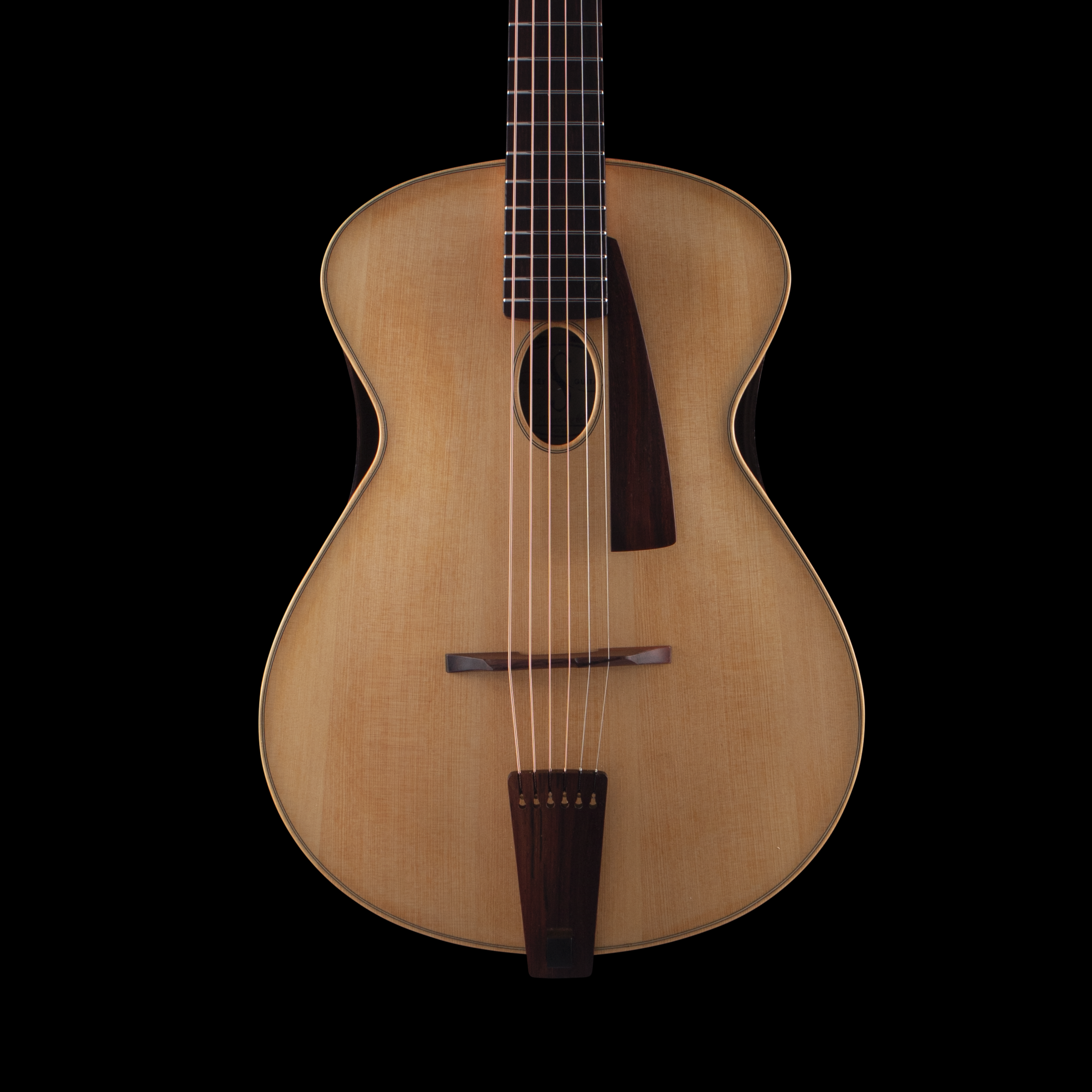 An acoustic Sankey guitar with a light wood body and dark wood neck, set against a black background.