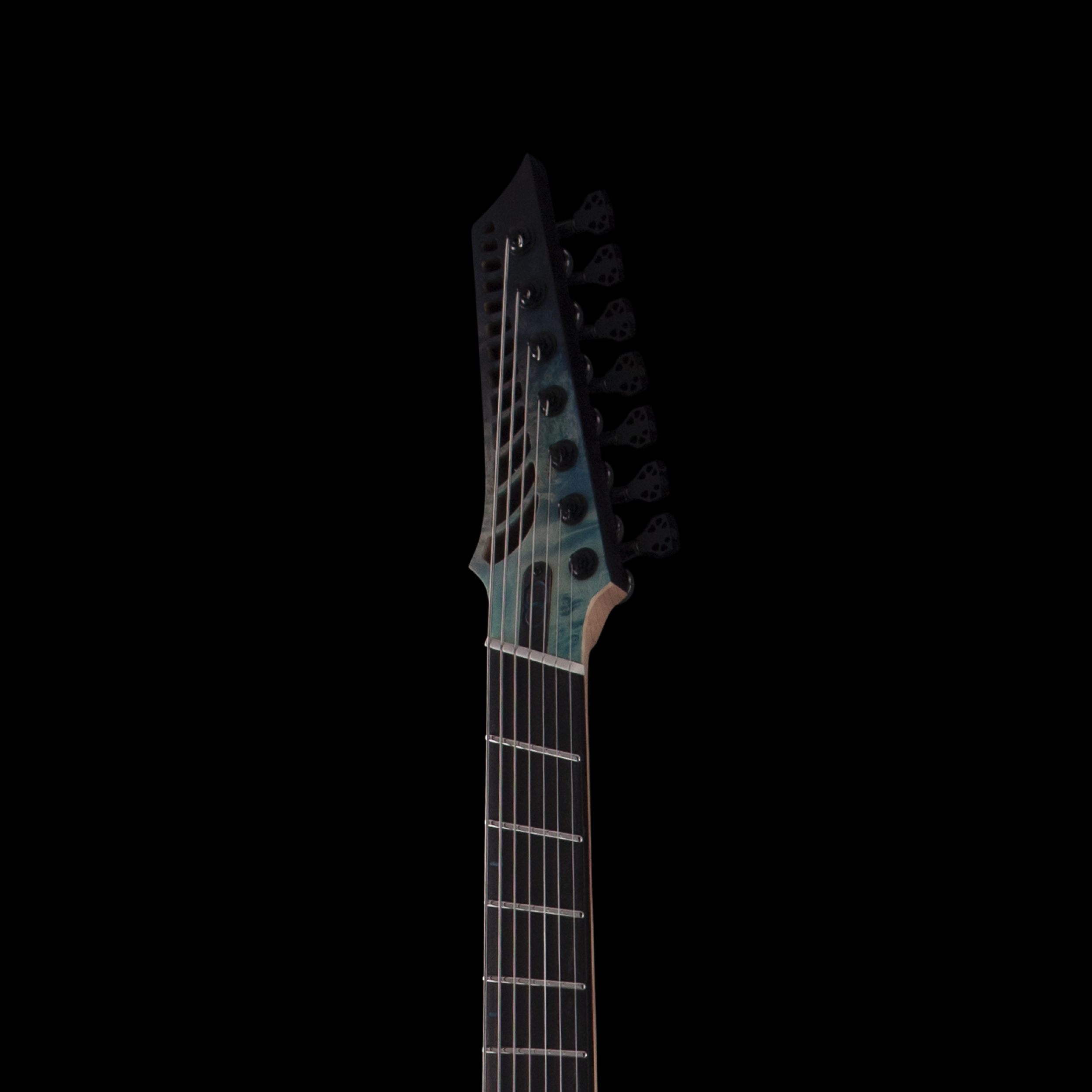 Close-up of the headstock of a black electric OD guitar with tuning pegs on a black background.