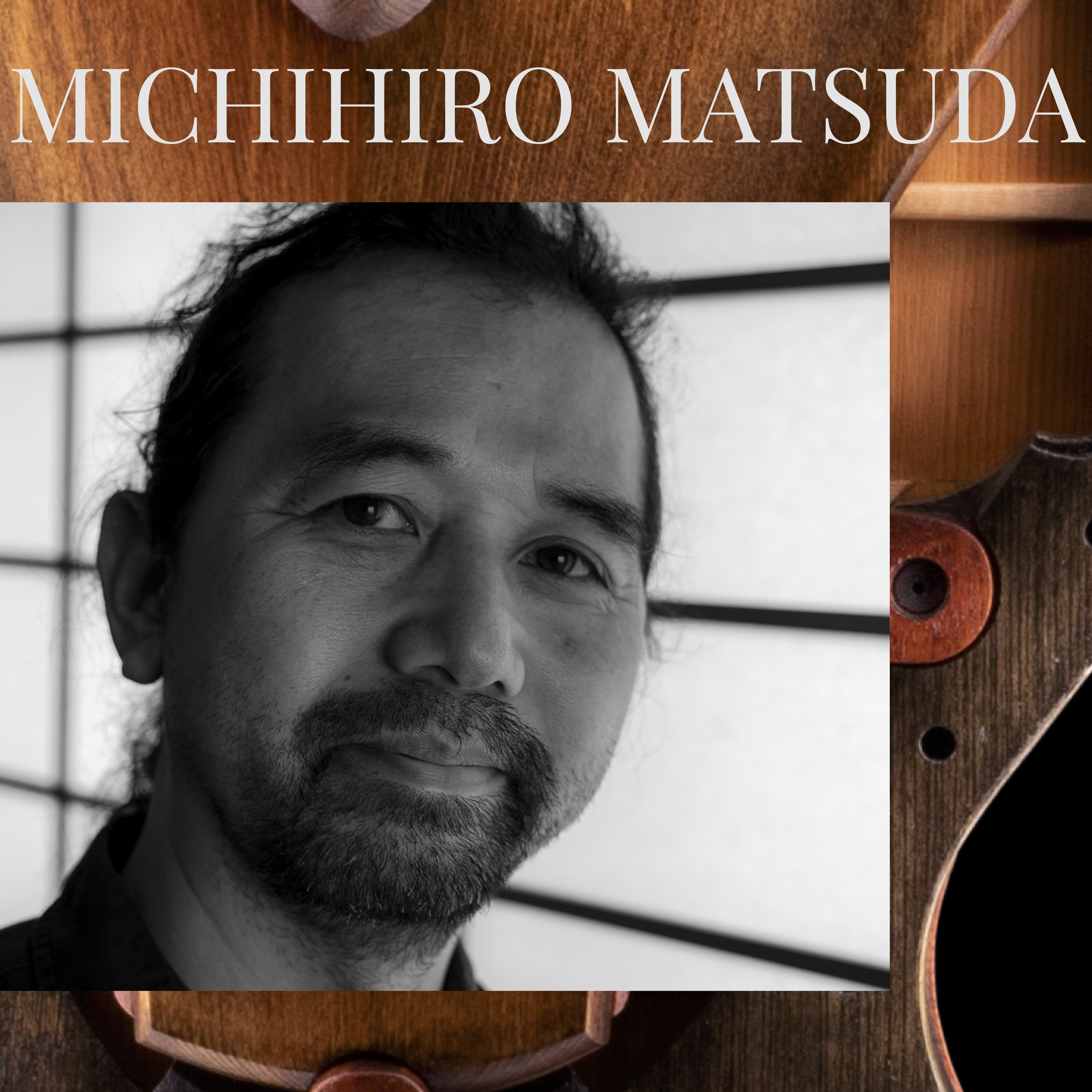 Partial view of Michihiro Matsuda with short black hair and a black shirt, looking at the camera, with a wooden table and a chair in the background.