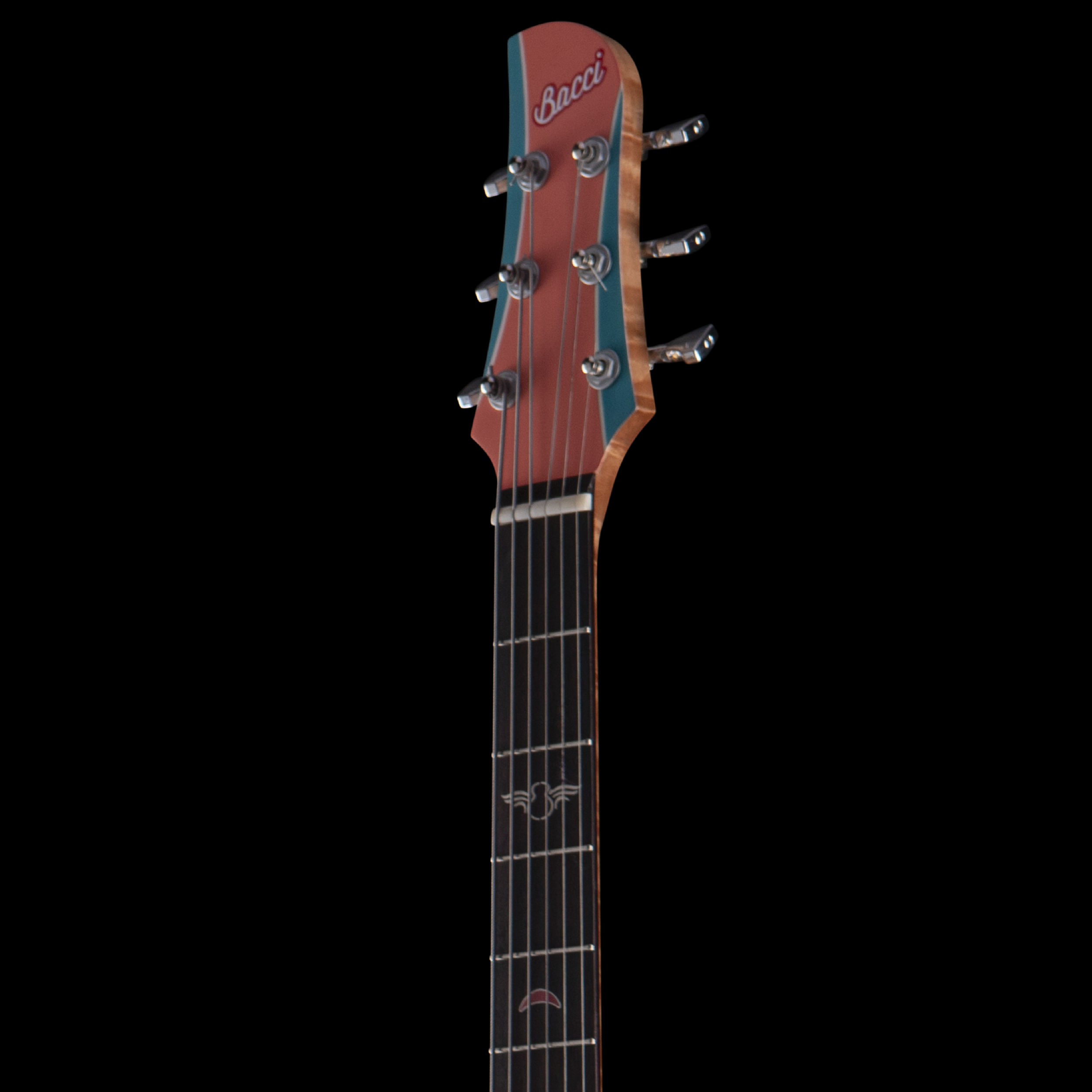 Close-up view of a Bacci guitar headstock with tuning pegs, showing the brand name 'Bacci' on the headstock against a black background.