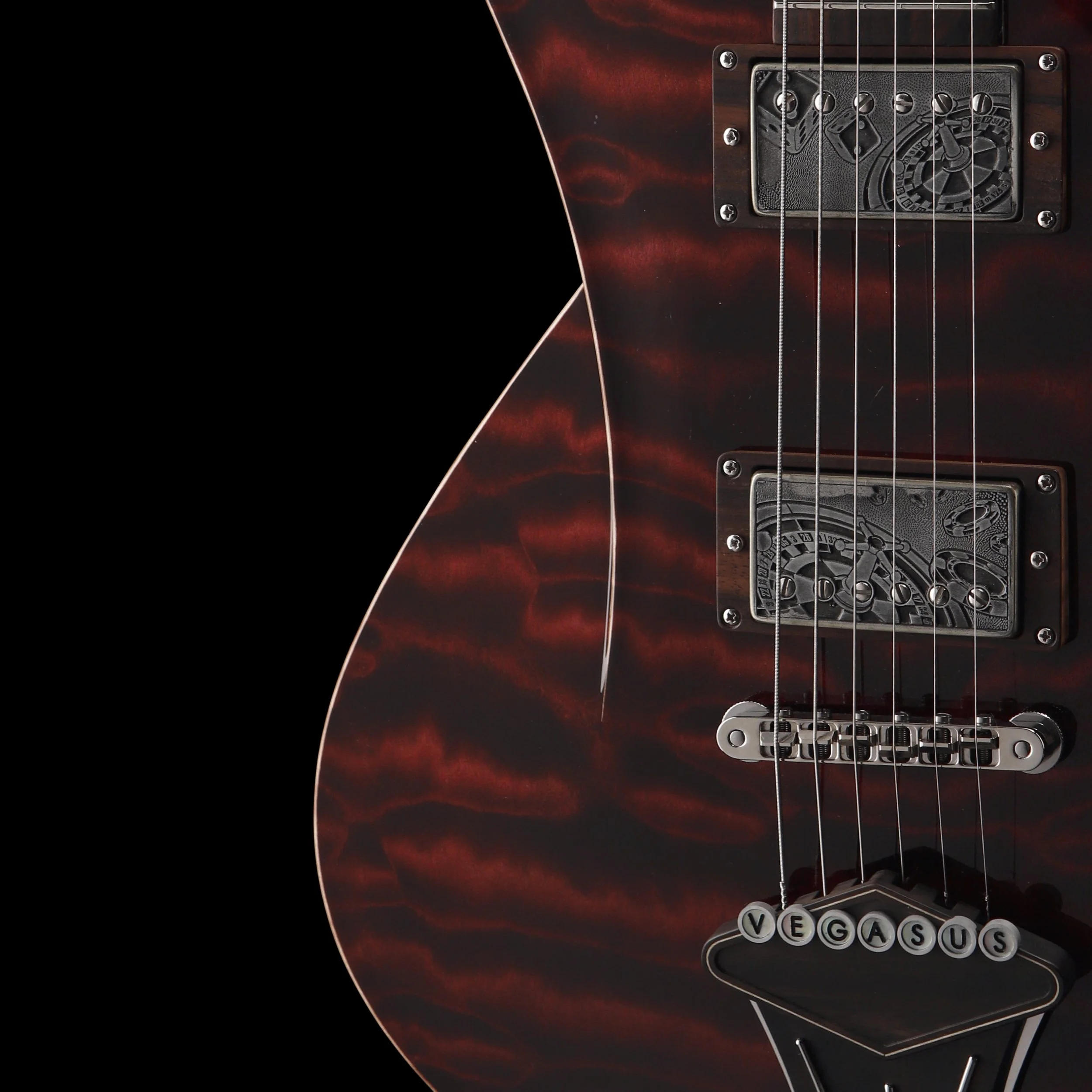 Close-up of an electric Frank Hartung guitar with a red and black marble-like finish, showing the pickups, bridge, and tailpiece with the word 'VEGASUS' on the tailpiece.
