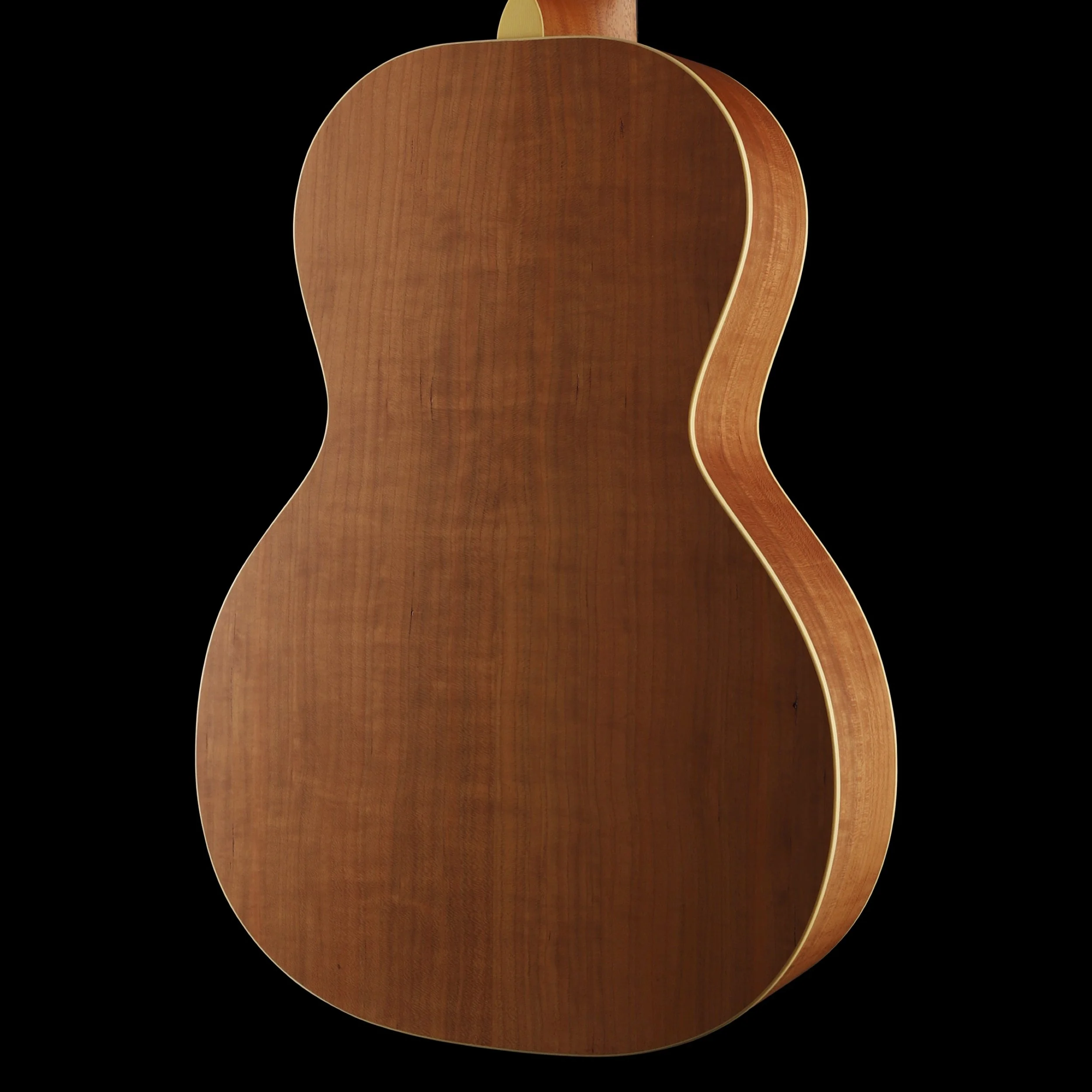 Rear view of a Lyon & Healy acoustic guitar body made of wood with a natural finish, set against a black background.