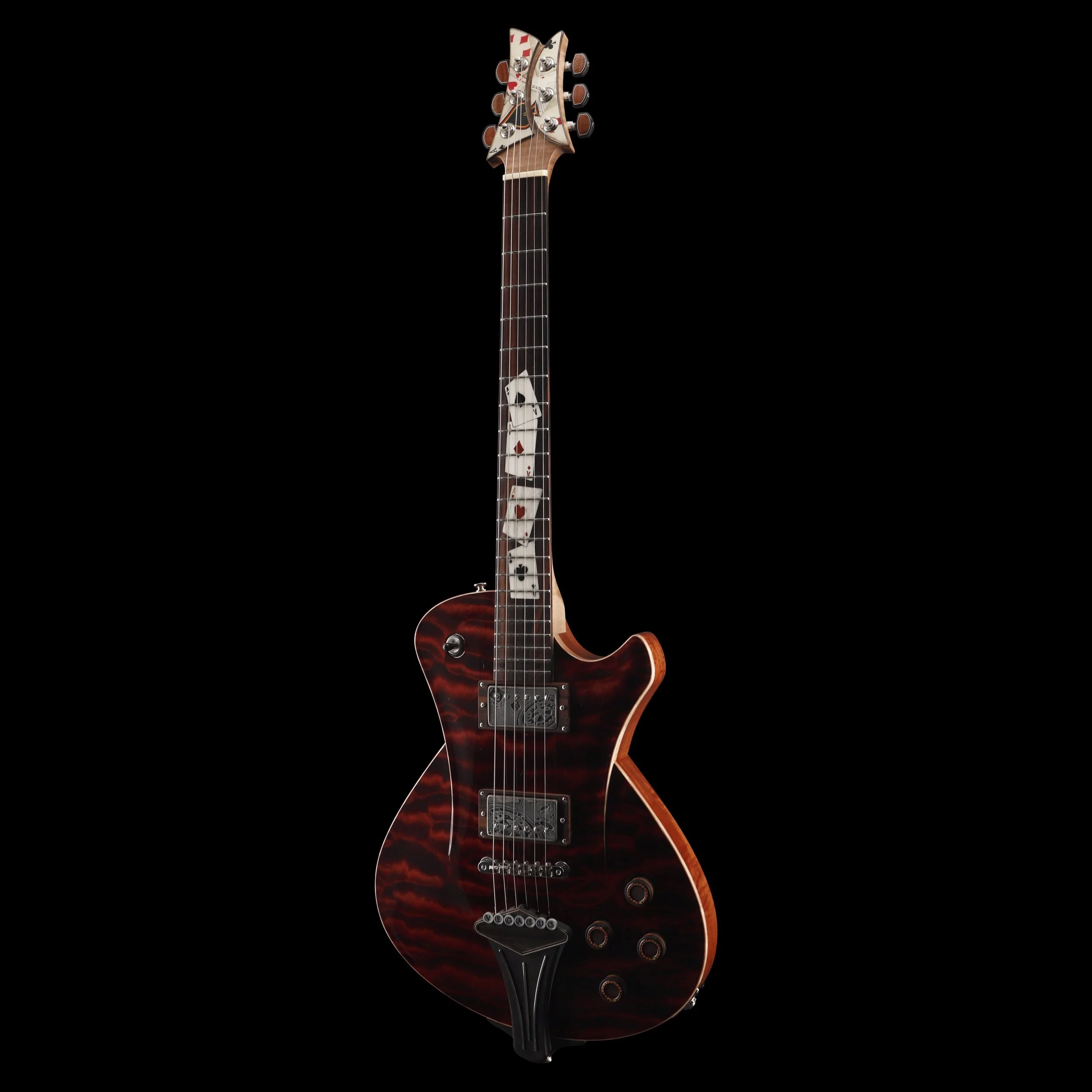 Electric Frank Hartung guitar with a red, tiger stripe finish and playing card symbols on the neck, set against a black background.