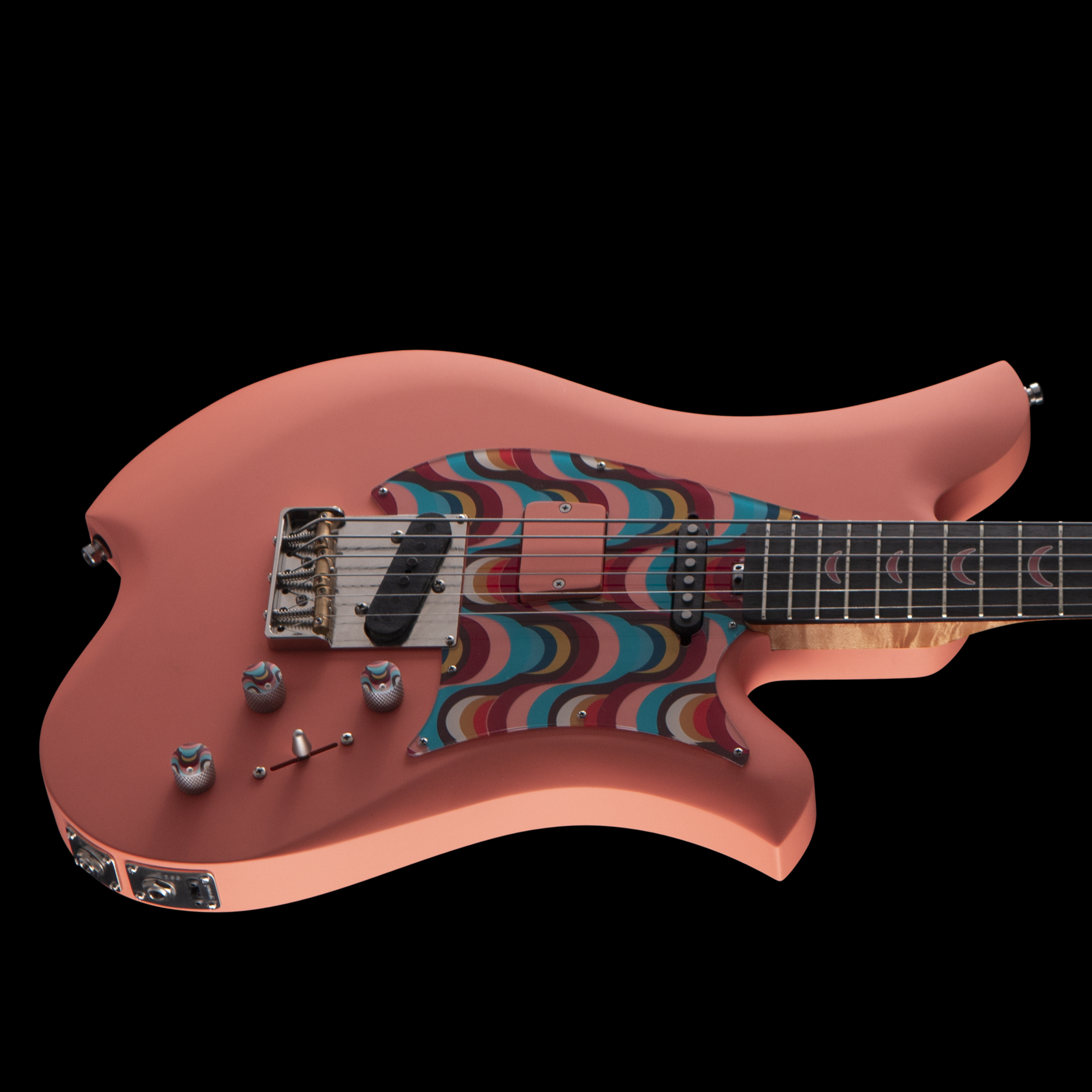 Pink electric Bacci guitar with a colorful rainbow swirl pattern on the pickguard, set against a black background.