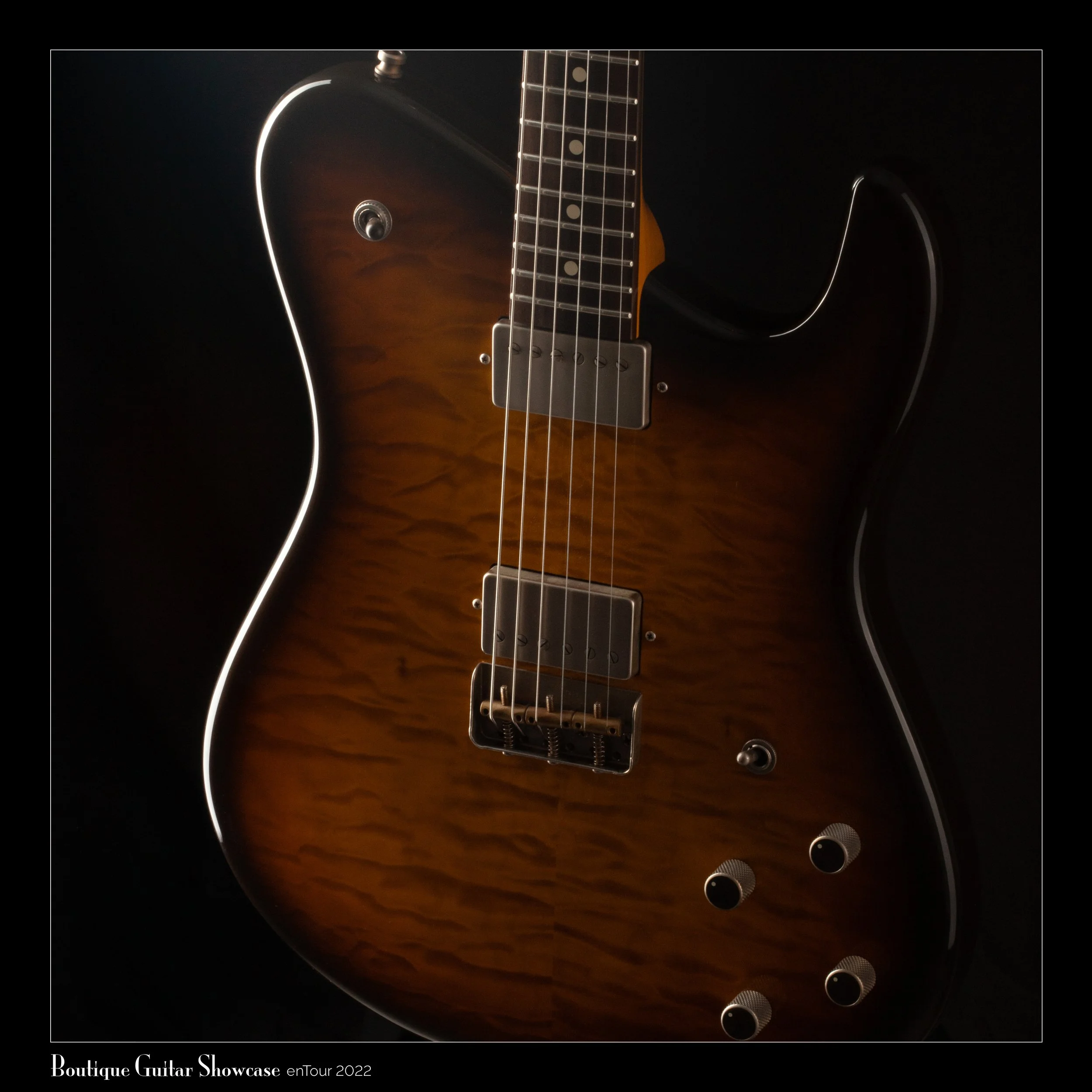 Close-up of a Tausch electric guitar with a sunburst finish, demonstrating texture and hardware details, dark background with subtle lighting.