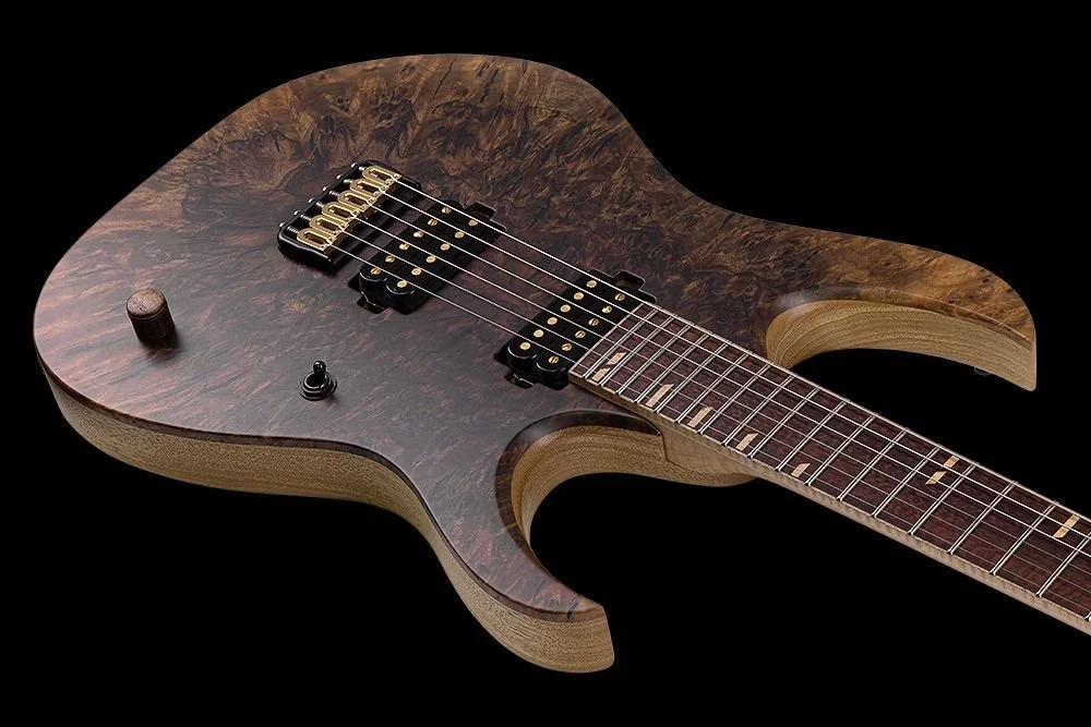 Close-up of an electric Mayones guitar with a dark wood grain body, visible pickups, and a fretboard against a black background.