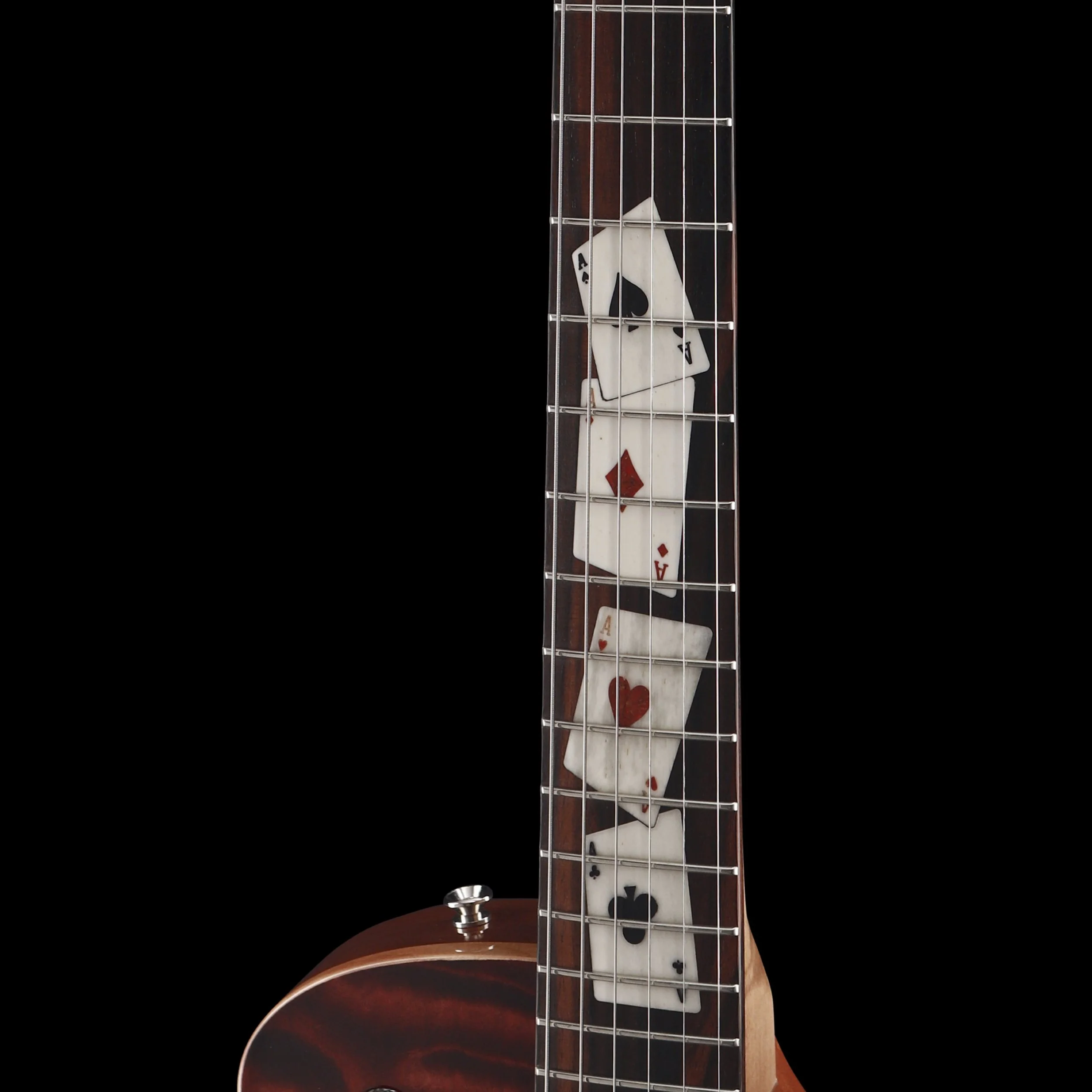 Close-up of a Frank Hartung guitar neck with playing cards inside the fretboard, including an ace of spades, ace of diamonds, ace of hearts, and ace of clubs.