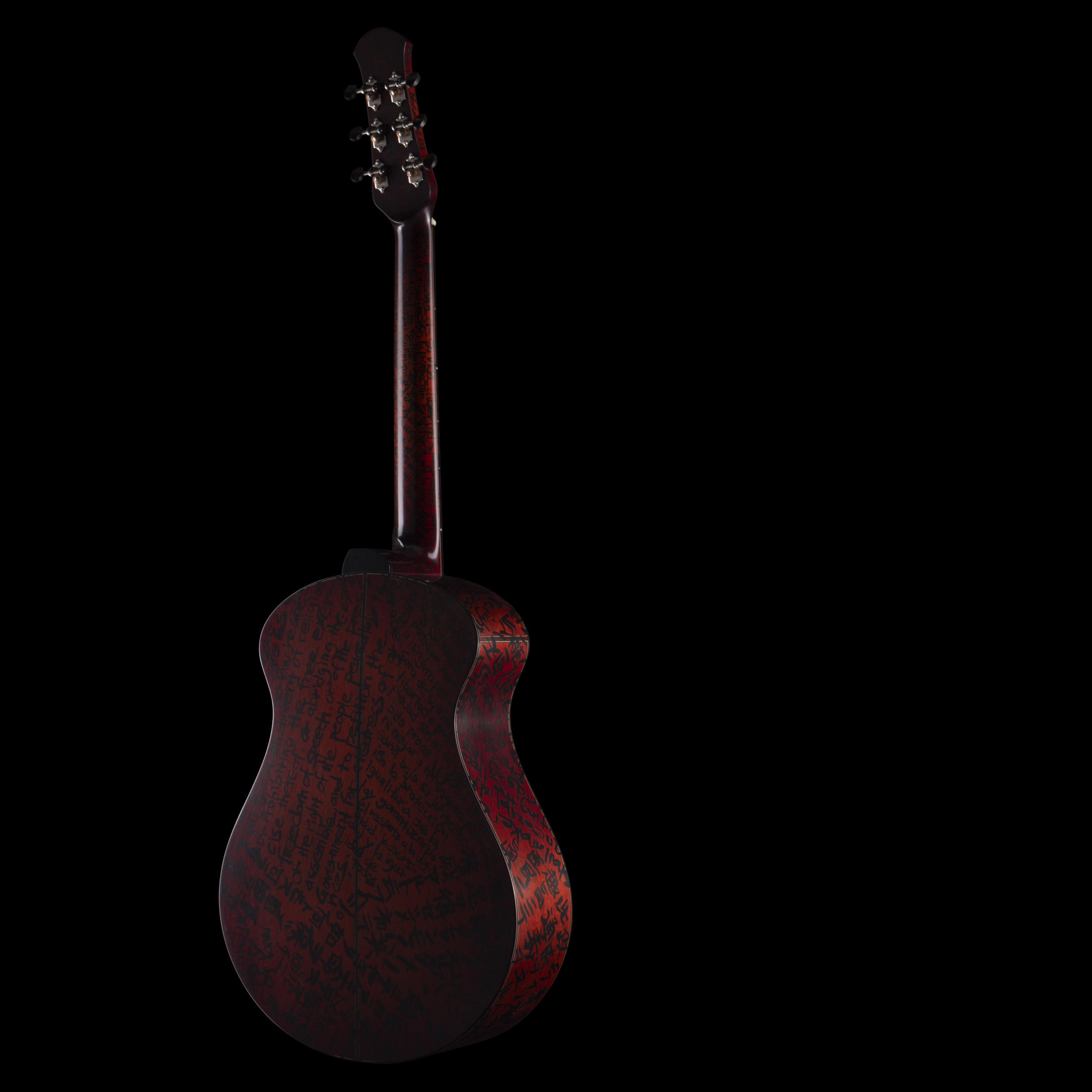 A Matsuda guitar with a dark red body featuring handwritten text in black, viewed from the back against a black background.