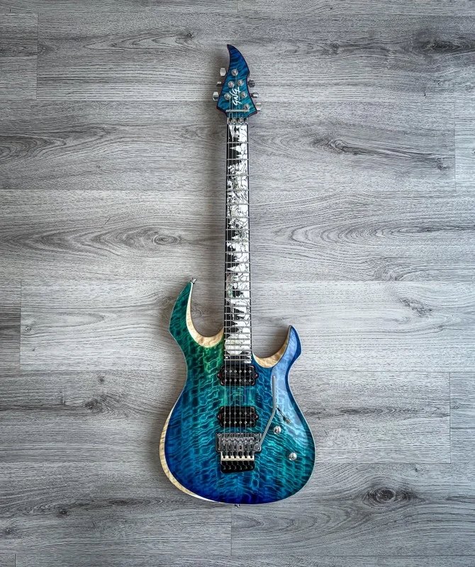 GNG Giulio Negrini Guitar with a blue and green quilted maple top, set on gray wooden floor.