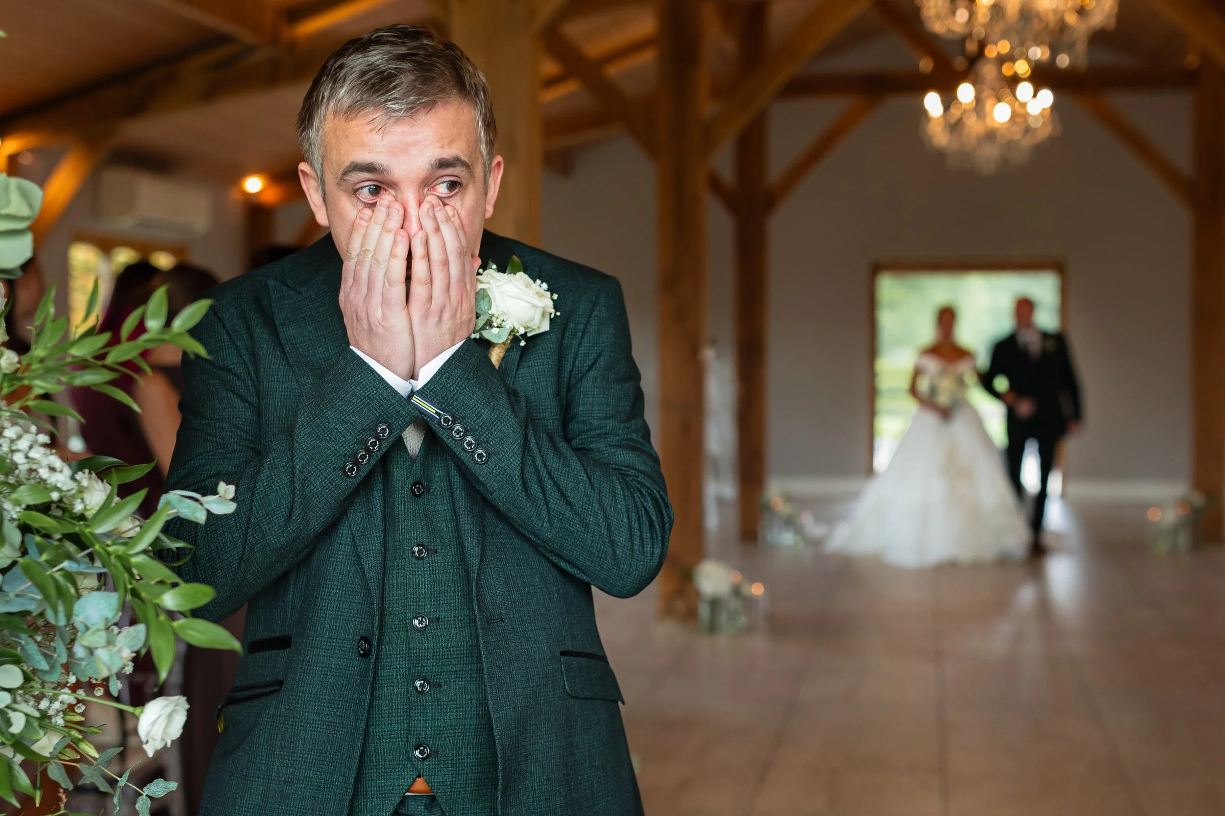 Groom becomes emotional as he sees the bride walking down the aisle at Merrydale Manor during their wedding ceremony.