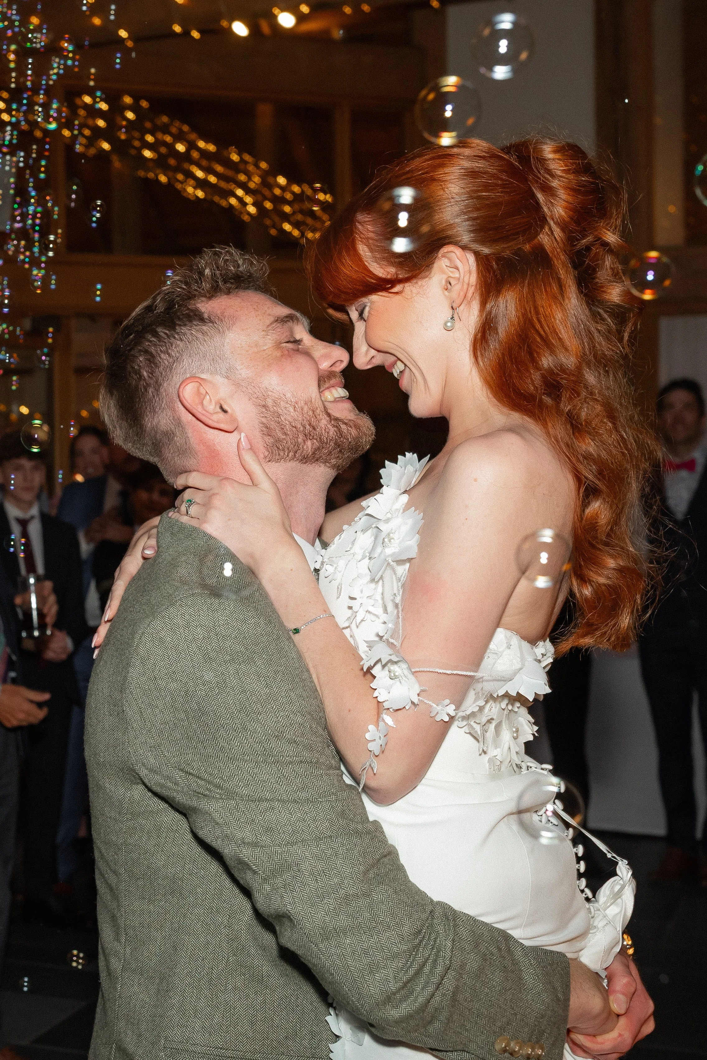 A bride being picked up by her husband at their wedding first dance.