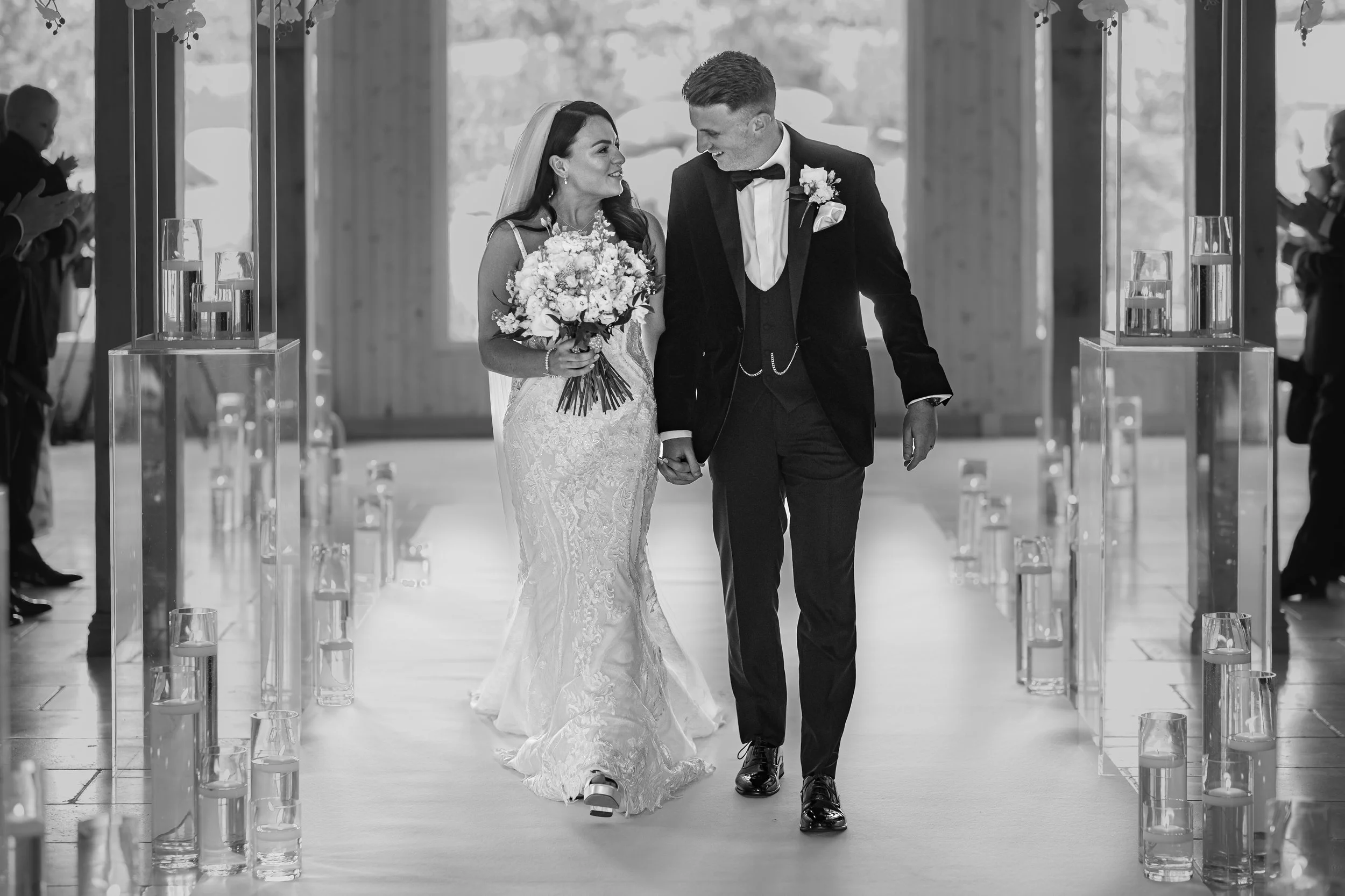 Newly married couple walking down the aisle together after their wedding ceremony in Cheshire.