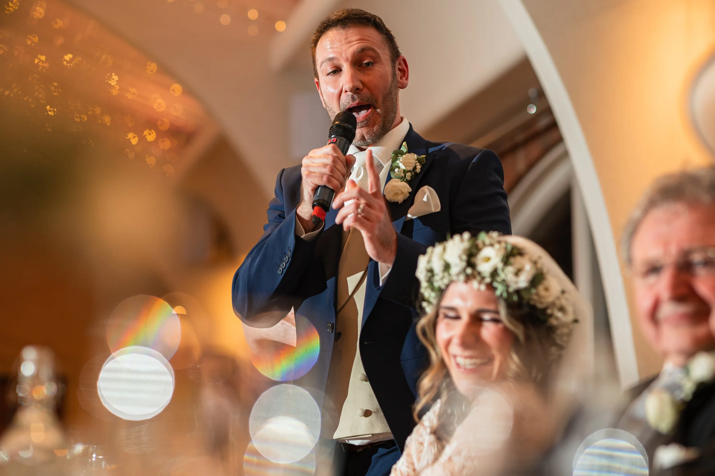 Groom delivering his wedding speech while guests laugh during the reception at Colshaw Hall