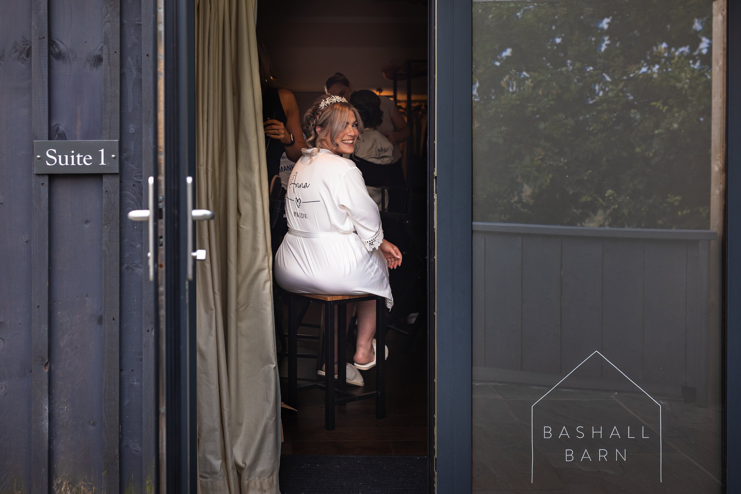 Bride getting ready in Suite 1 during morning preparations at Bashall Barn in Lancashire