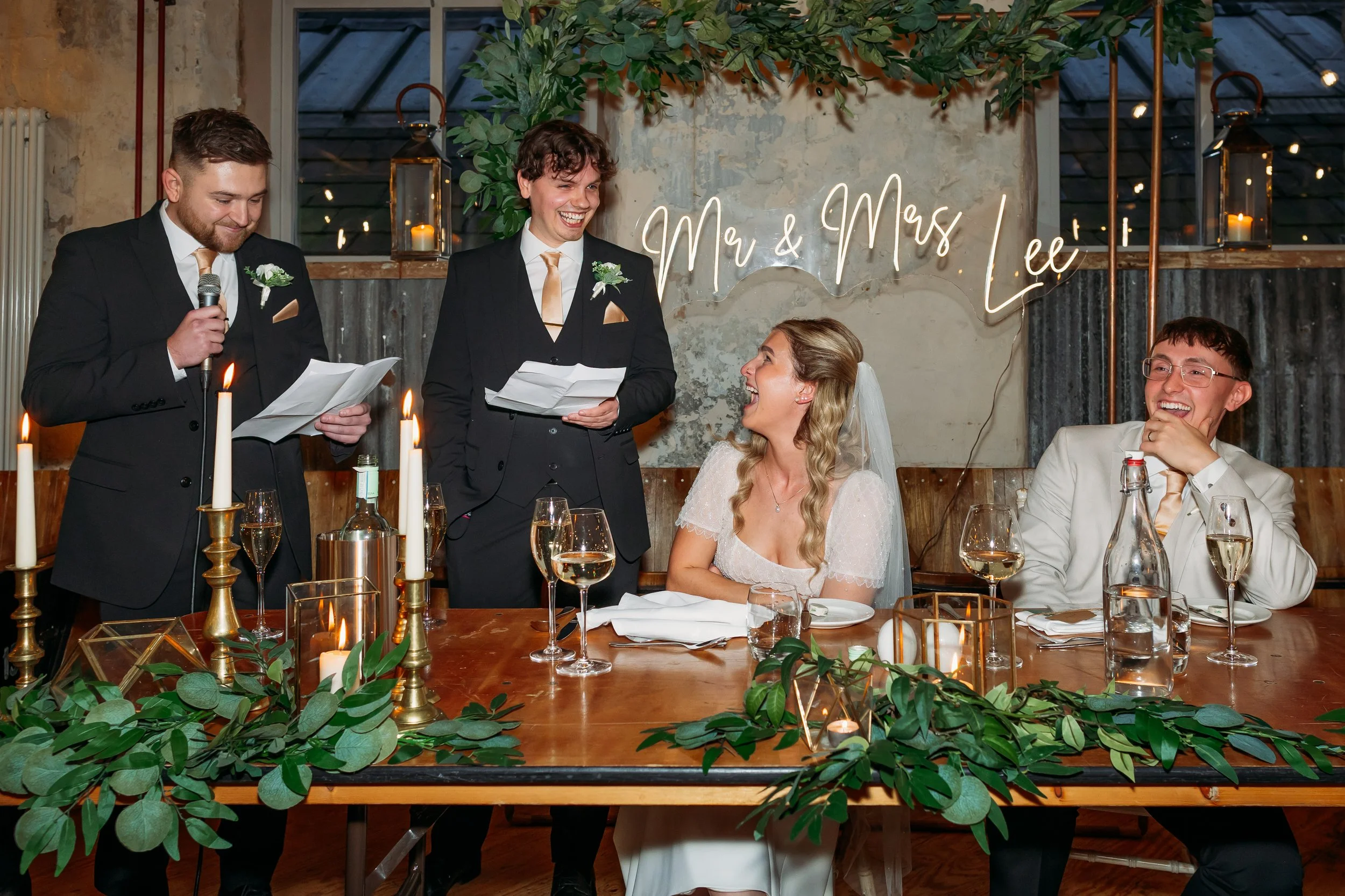 Best men giving their wedding speech at the top table during a reception at Holmes Mill in Lancashire