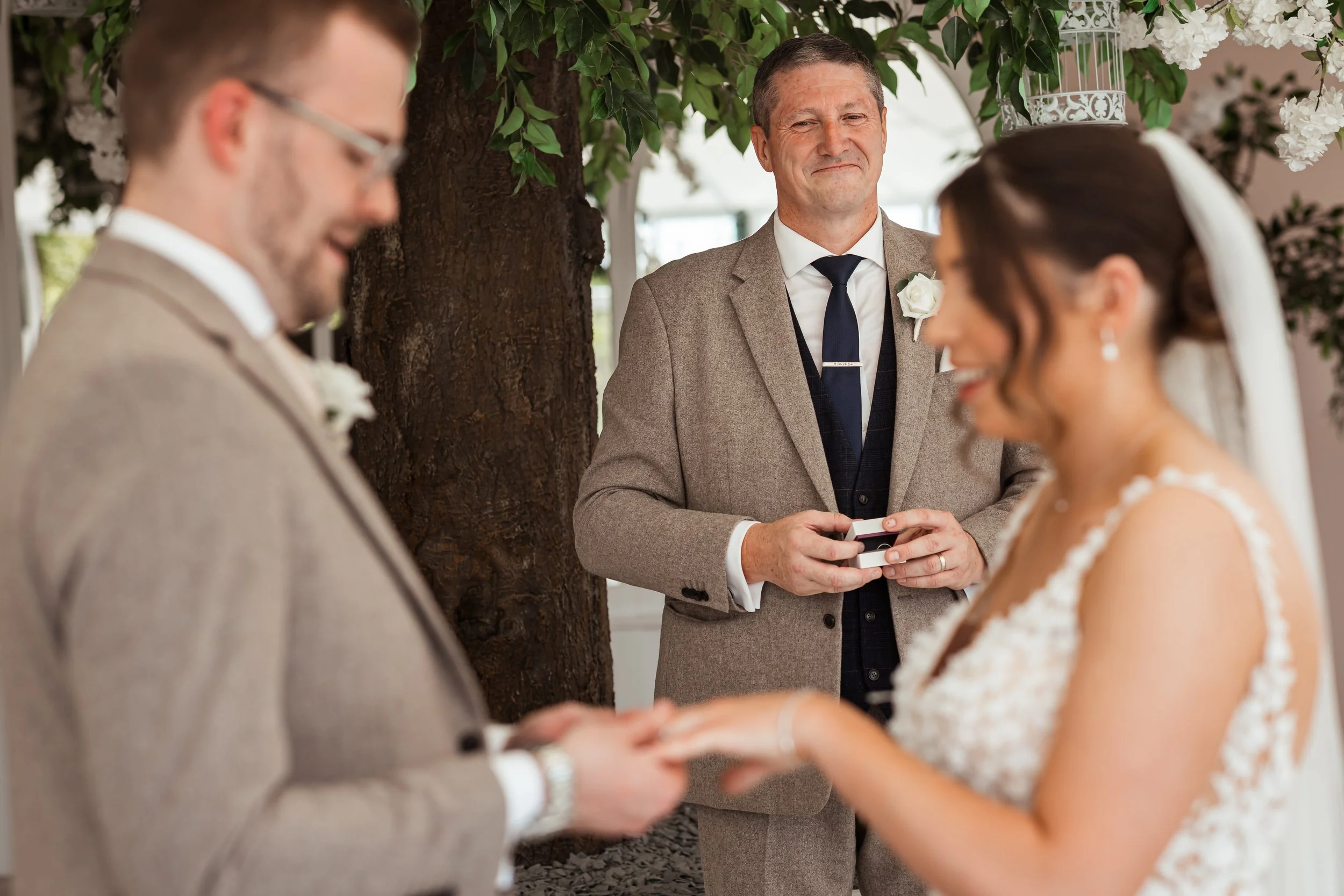combermere-abbey-wedding-ceremony-father-holding-rings.jpg