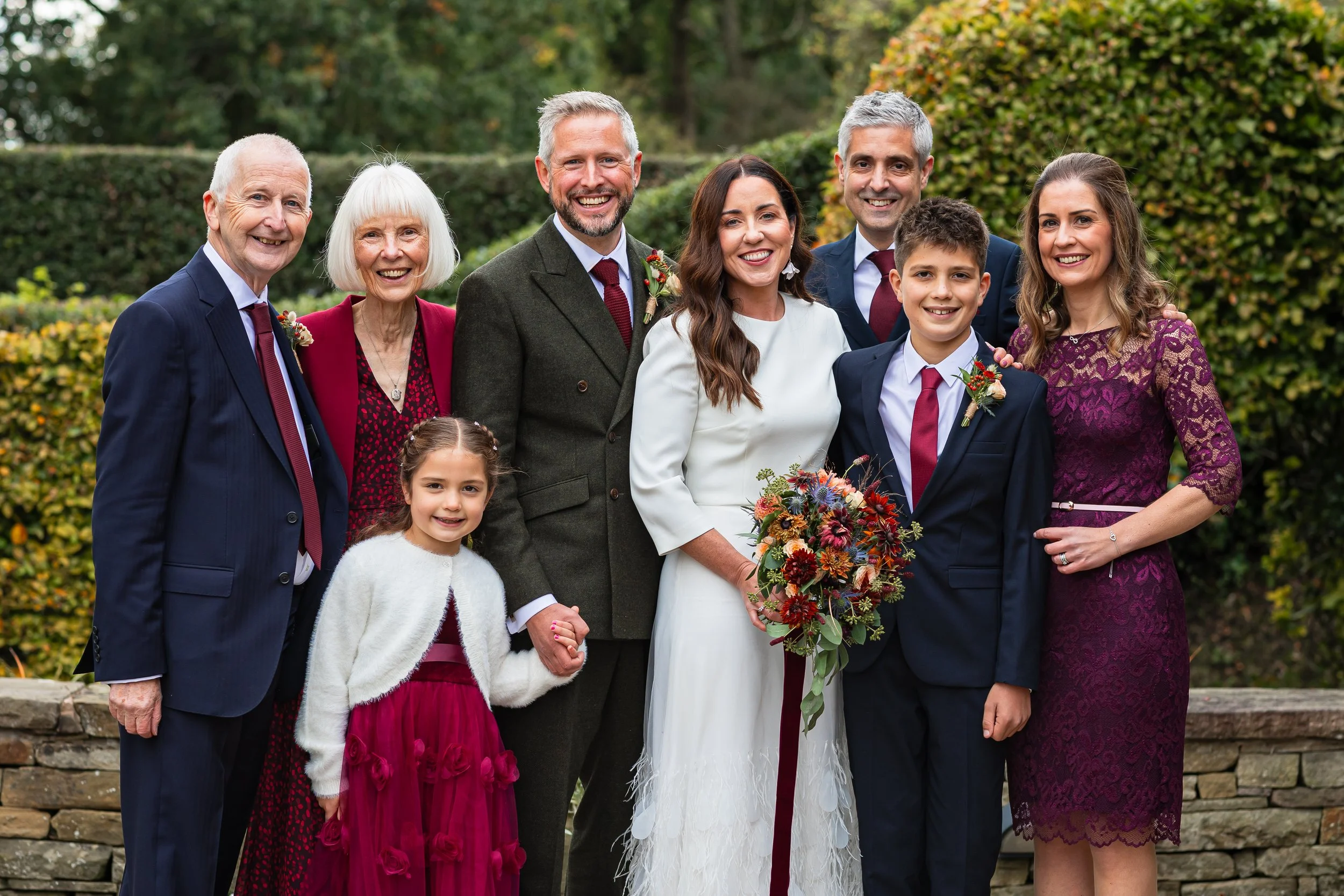 Family portrait during the drinks reception at Hilltop Country House wedding in Cheshire with the bride and groom surrounded by close family