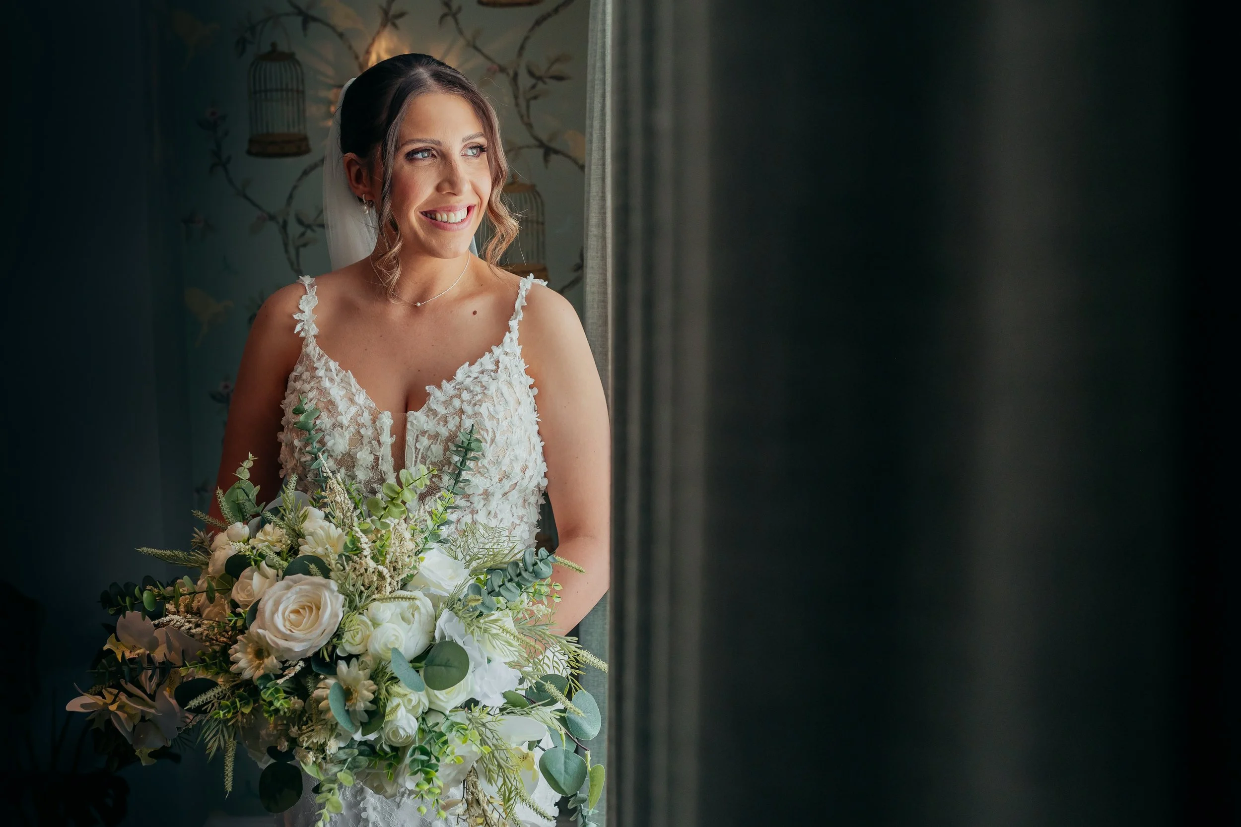Bride’s wedding dress being fastened during morning preparations at Combermere Abbey
