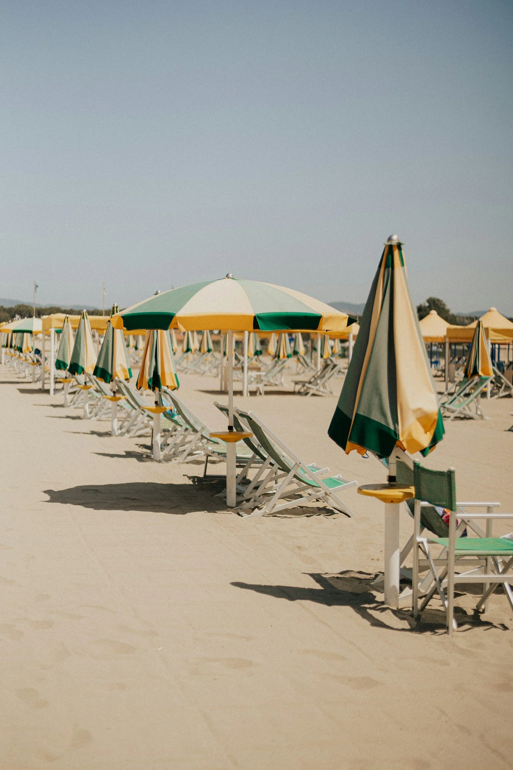 soft white beach sand with chairs and umbrellas