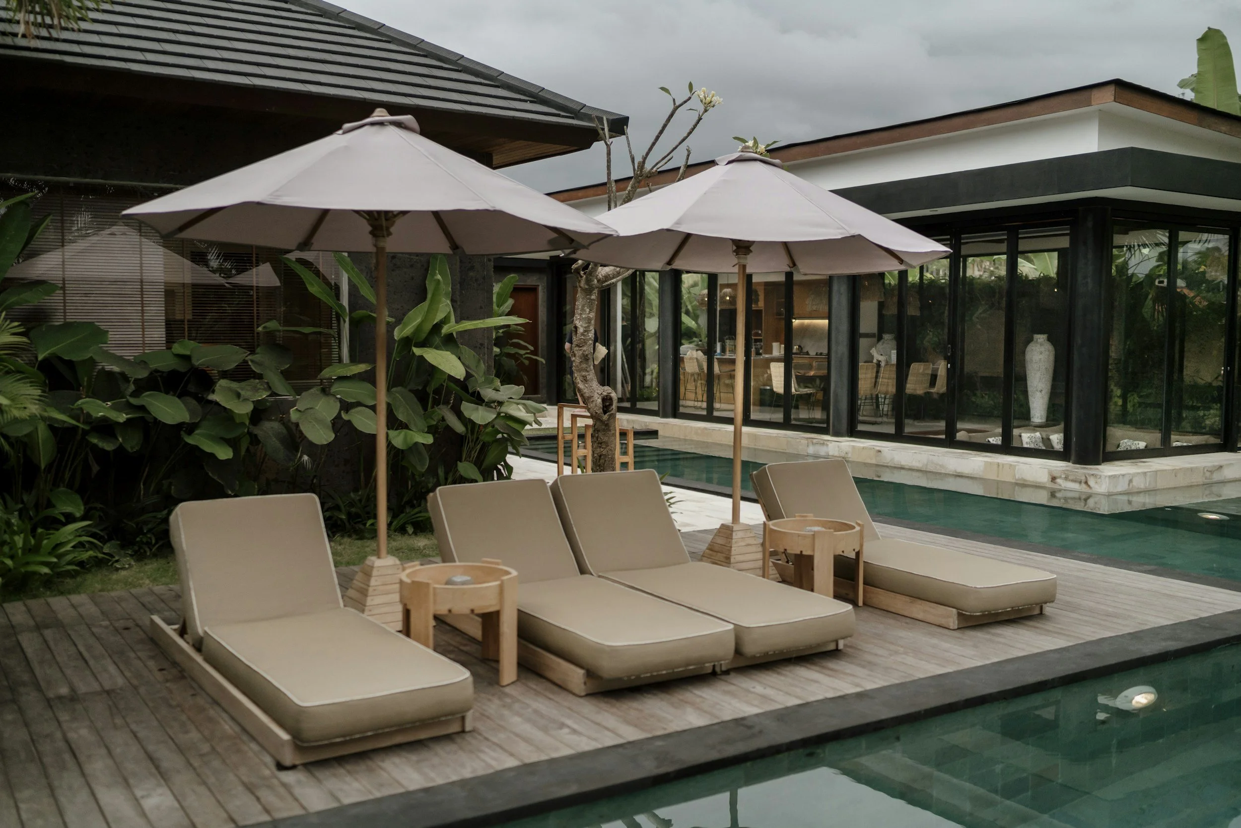 villa with pool and chairs