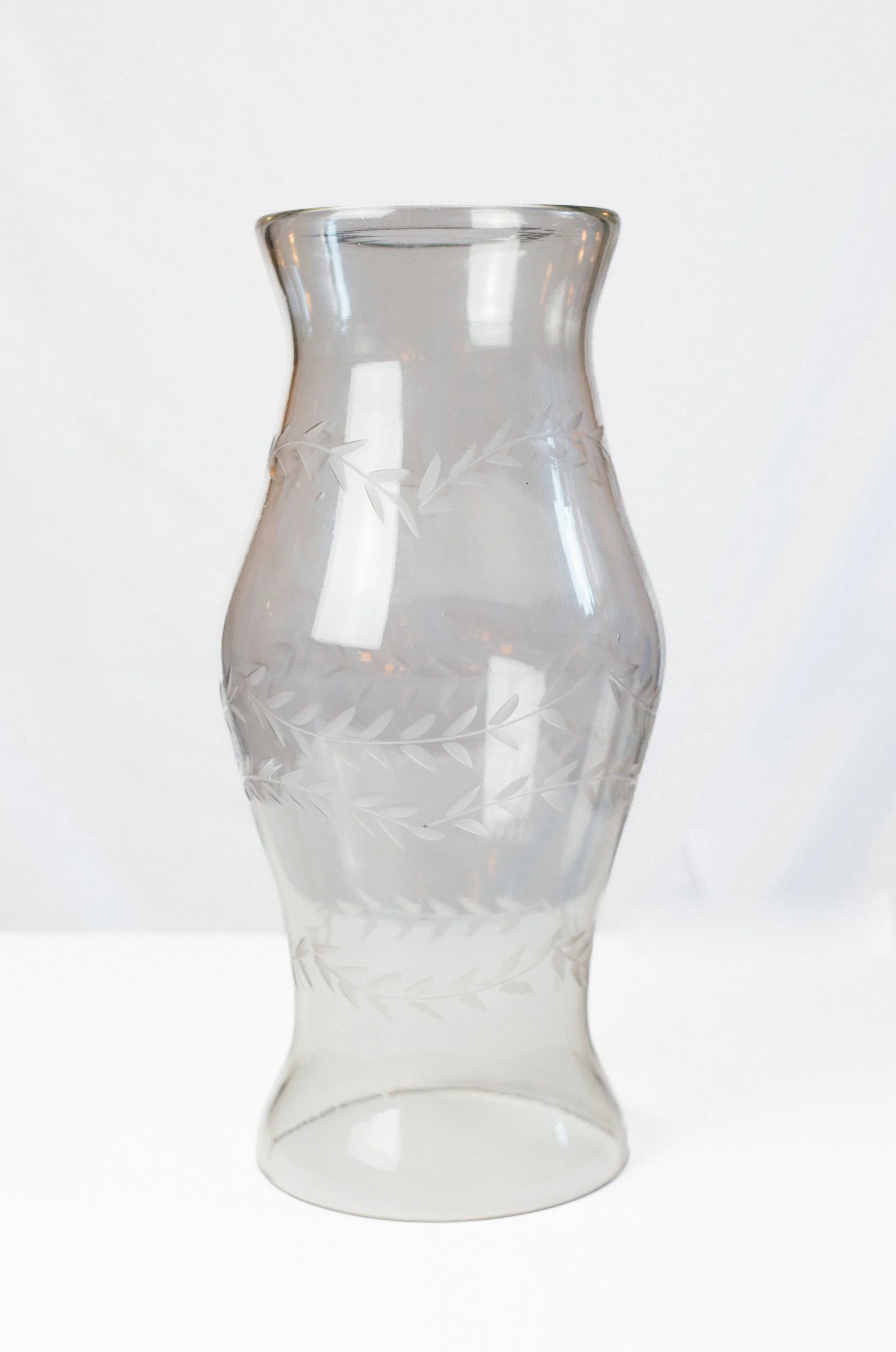 Hurricane glass centerpiece with leaf etched patterns